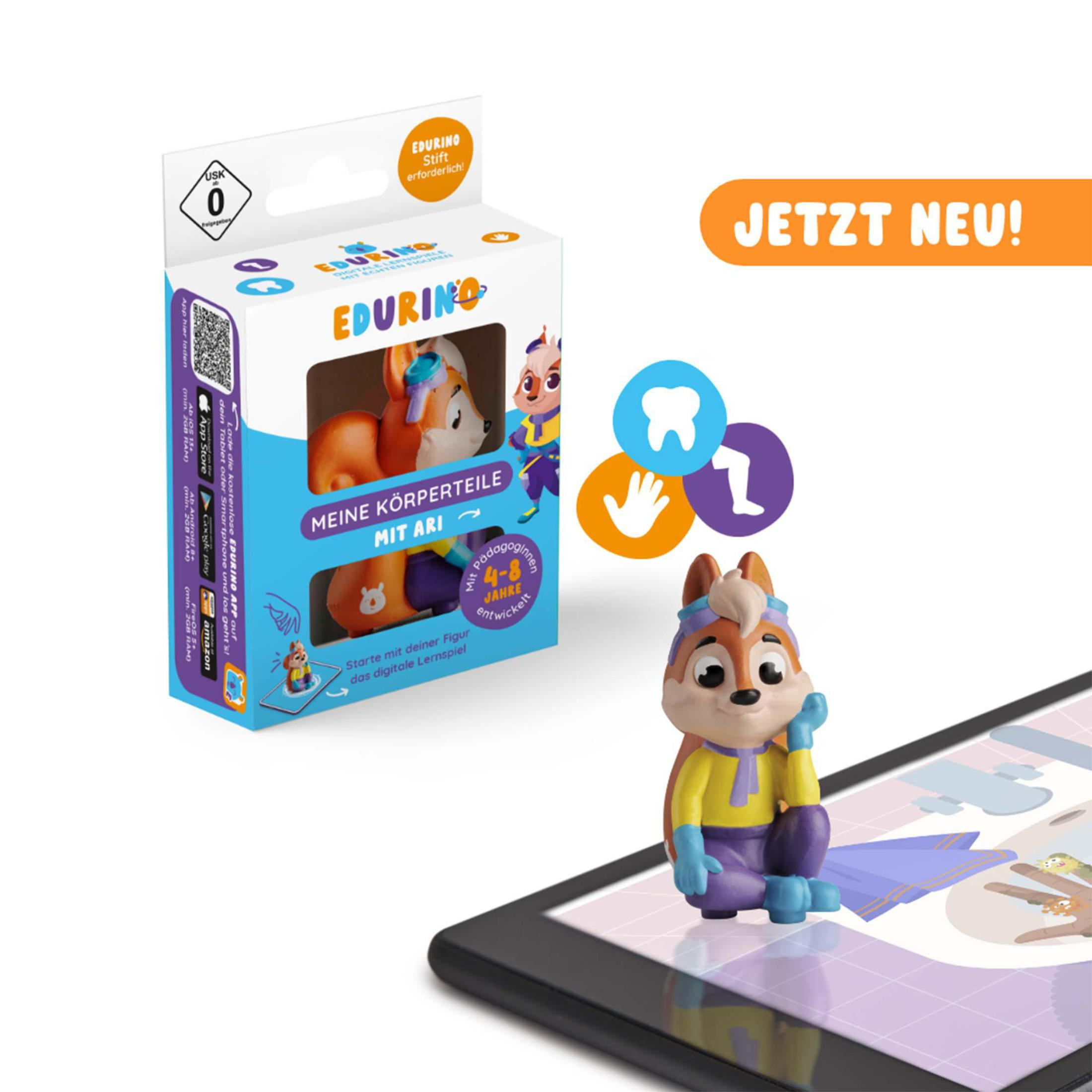 Eine Spielfigur, eine Box und ein Tablet mit einer bunten Illustration.