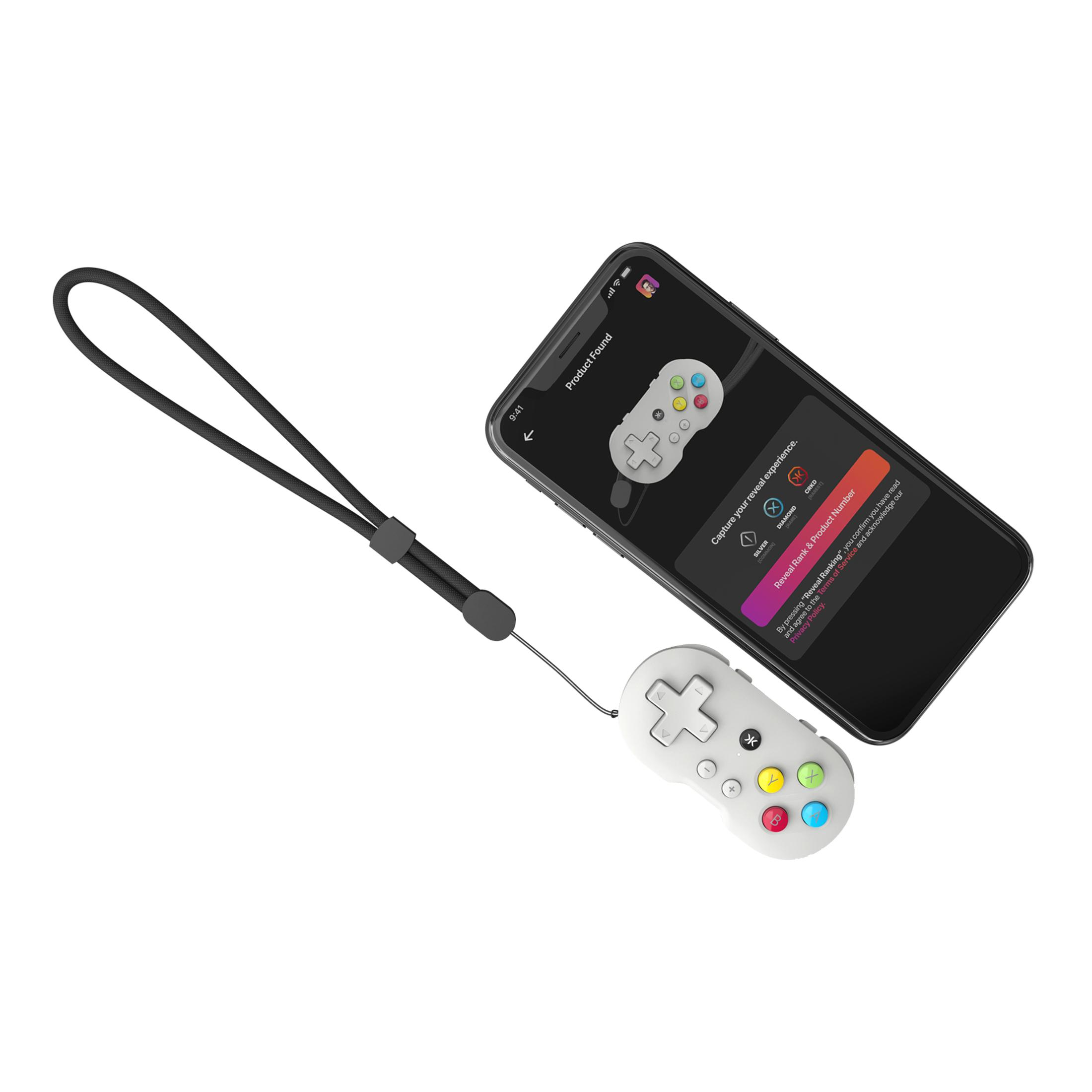 Ein weißes Mini-Gamepad und ein Telefon, das eine Gamepad-App zeigt. Das Gamepad hat bunte Knöpfe.