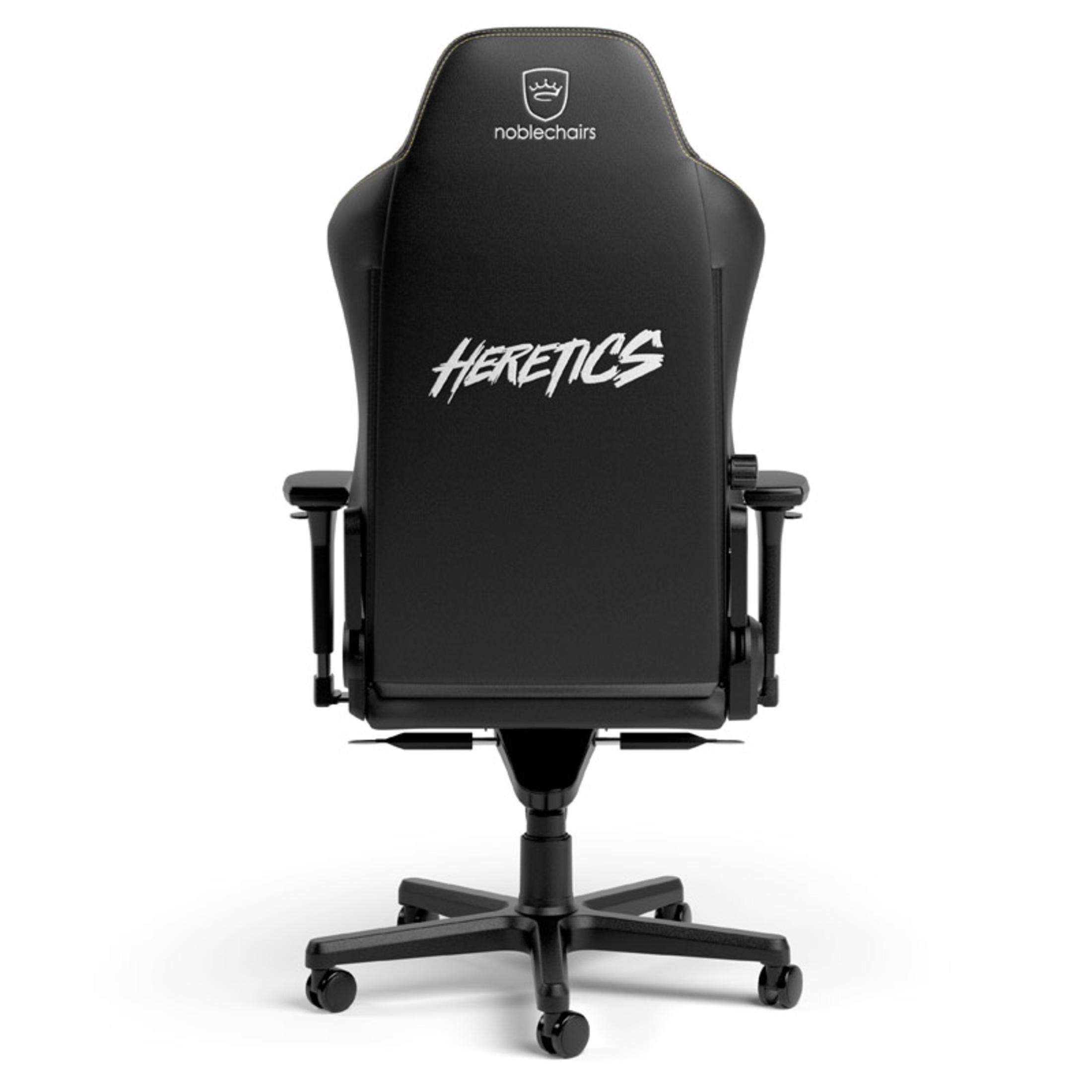 Silla gaming negra, vista trasera, con texto "HERETICS" y logo blancos.