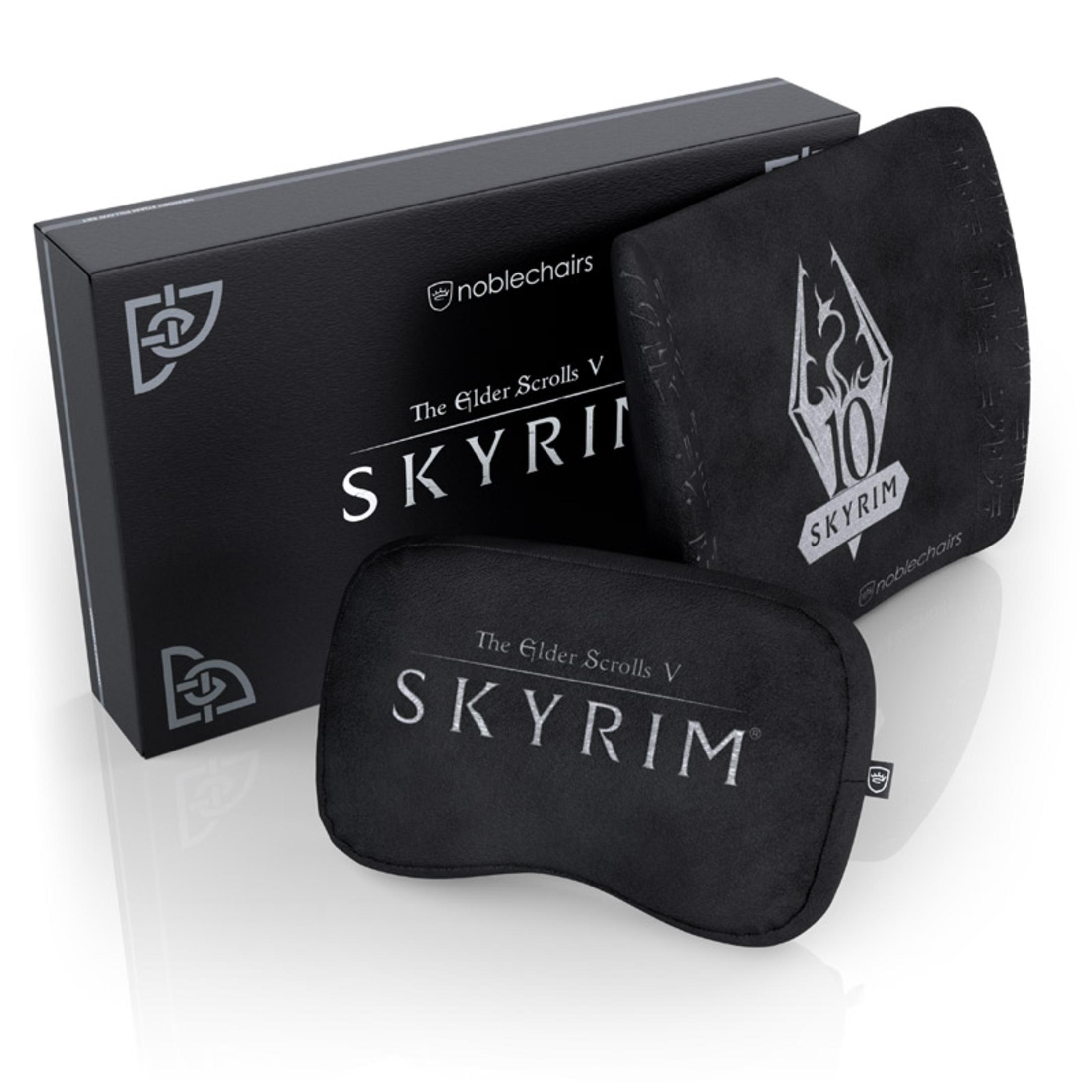 Eine Schachtel mit dem Spielnamen Skyrim und zwei schwarzen Kissen im Skyrim-Design.