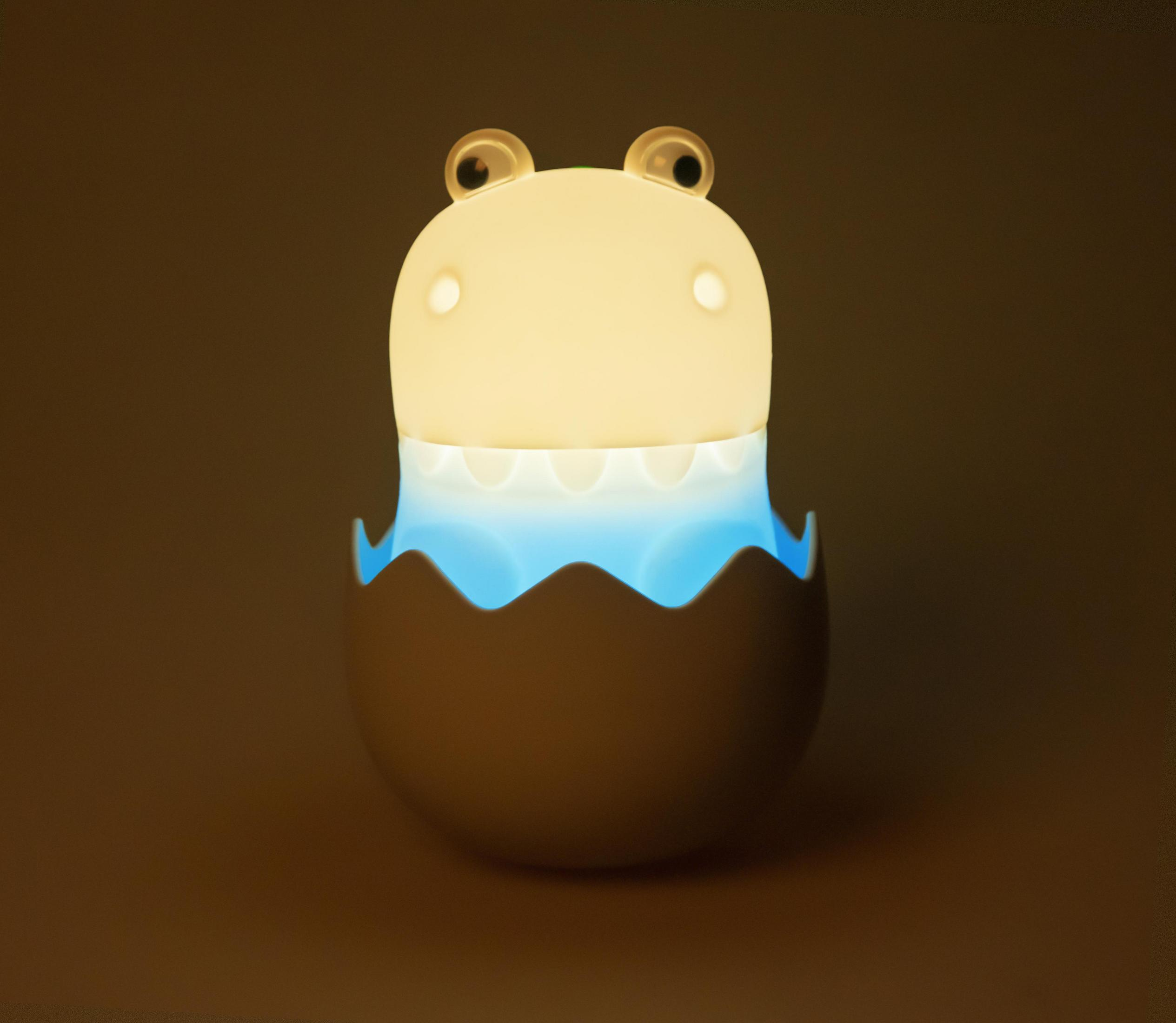 Nachtlicht in Form eines Cartoon-Frosches in einer Eierschale, mit blau-gelben Farbtönen.