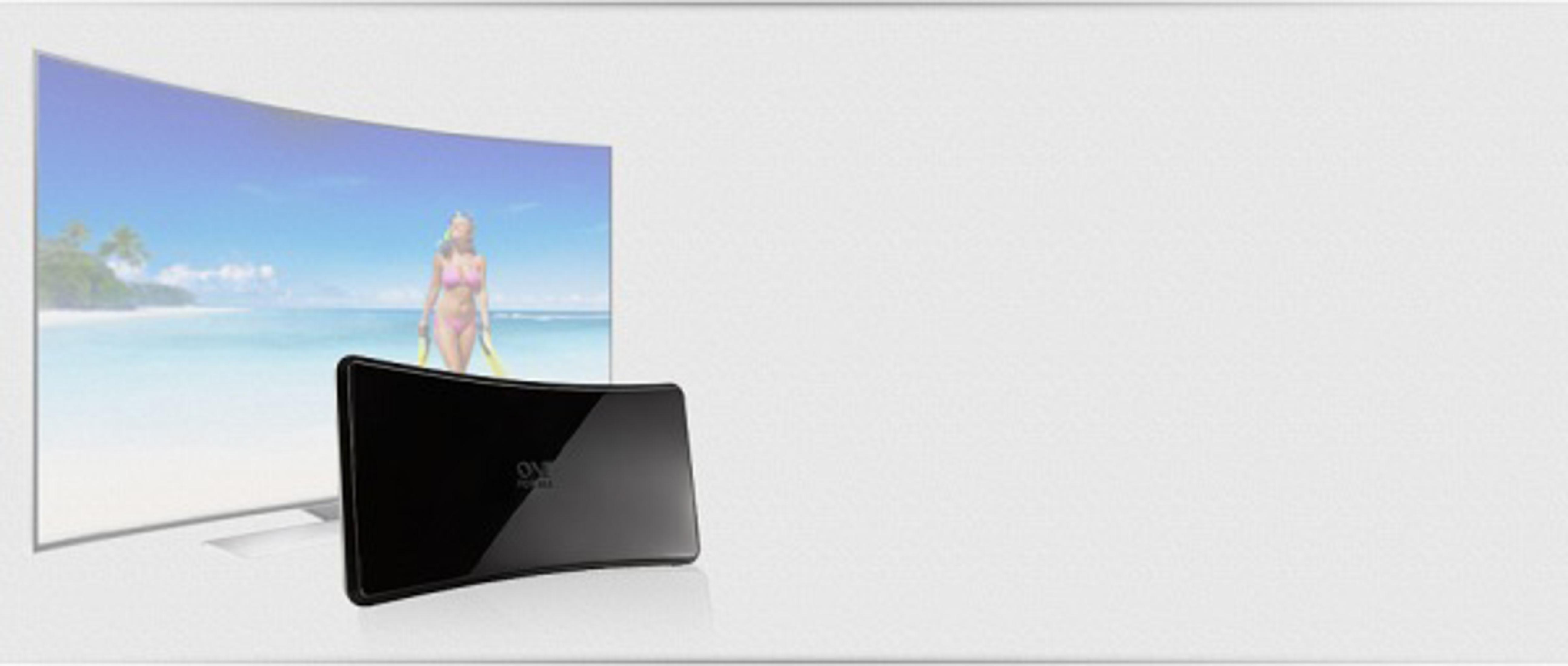 Curved TV showing a beach scene, with a black device in front.