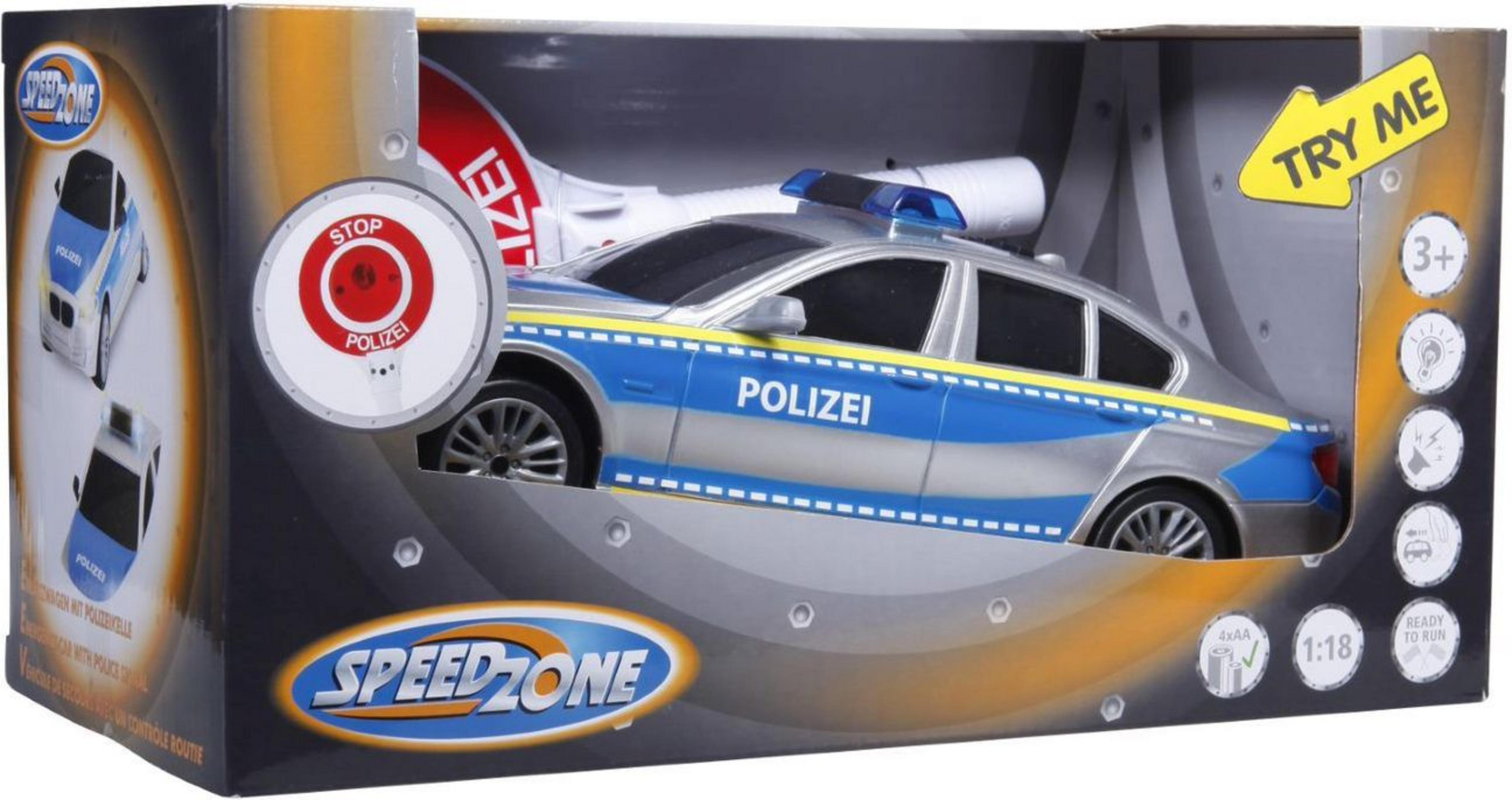 Ein Polizeiauto-Spielzeug in einer Box mit Stoppschild und dem Wort POLIZEI.