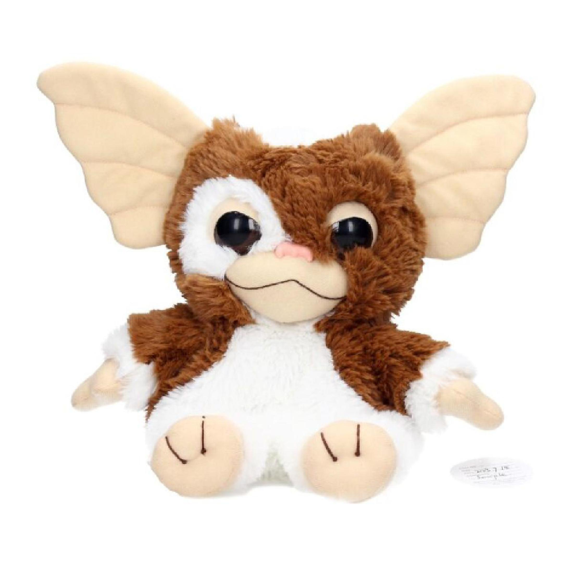 Un peluche Gremlin con pelliccia marrone e bianca, grandi orecchie e grandi occhi su sfondo bianco.