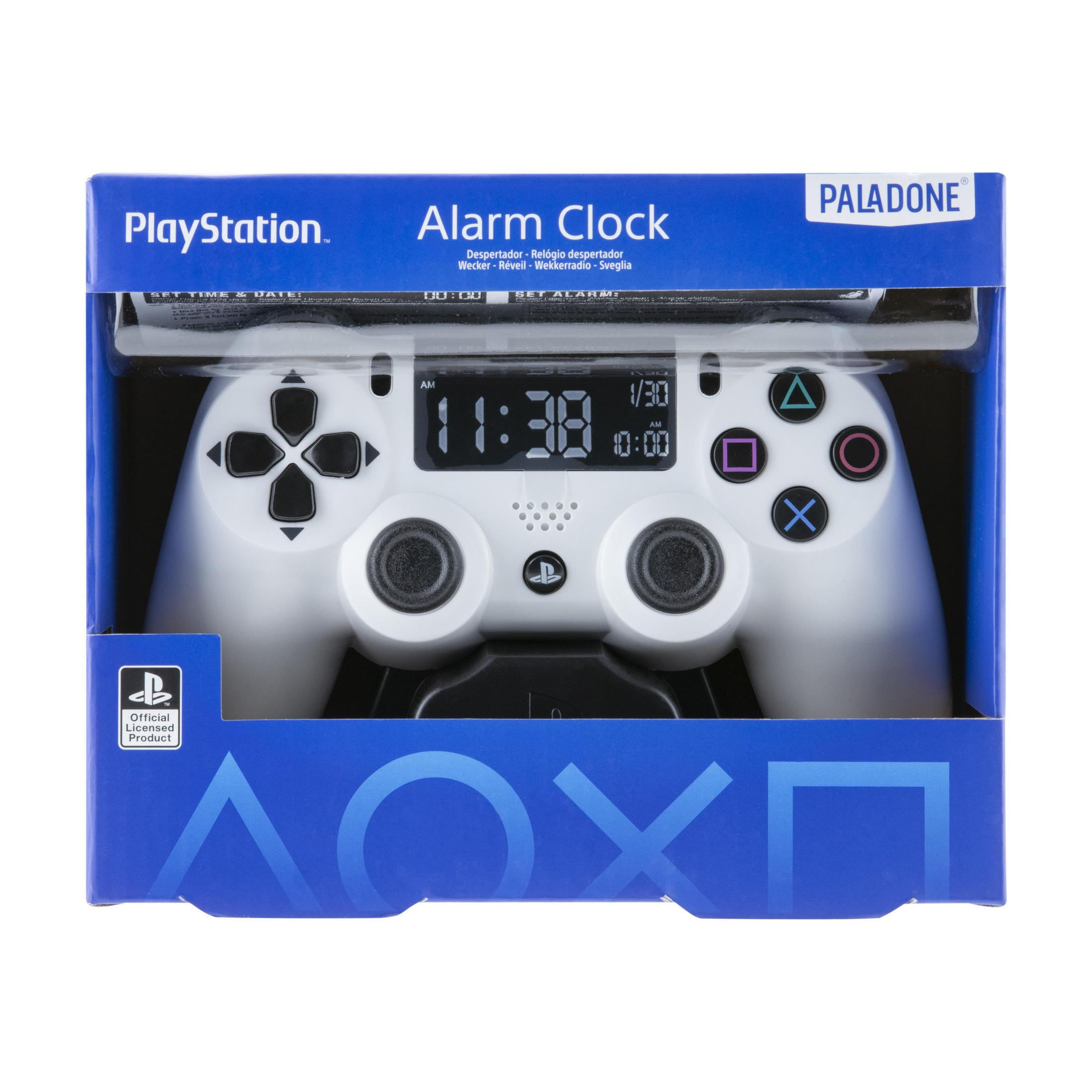Ein weißer PlayStation-Wecker in einer blauen Box. Die Uhr zeigt die Zeit 11:38 Uhr an.