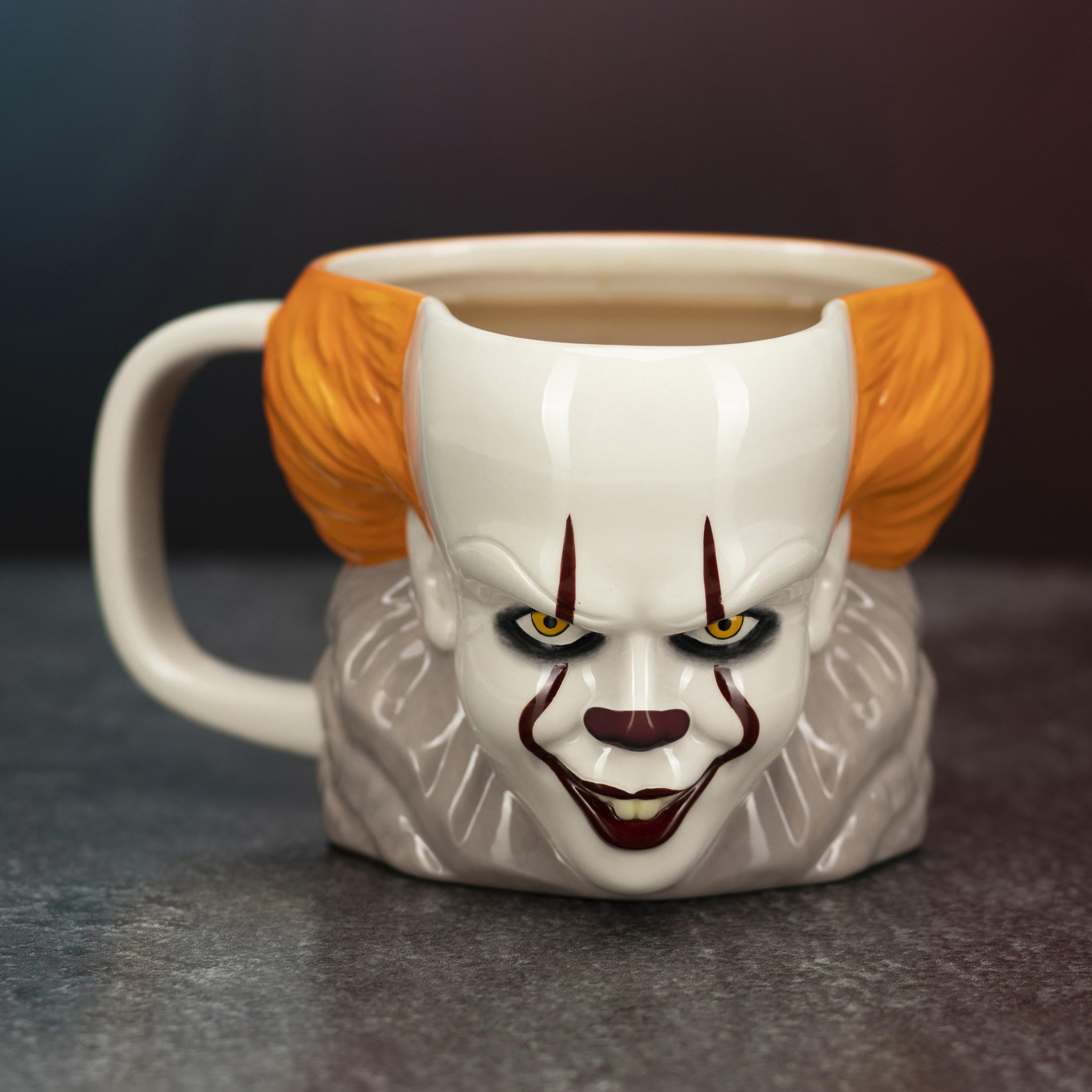 Pennywise-Tasse, weiß mit orangefarbenem Haar, rotem Clown-Make-up und grauem Kragen.