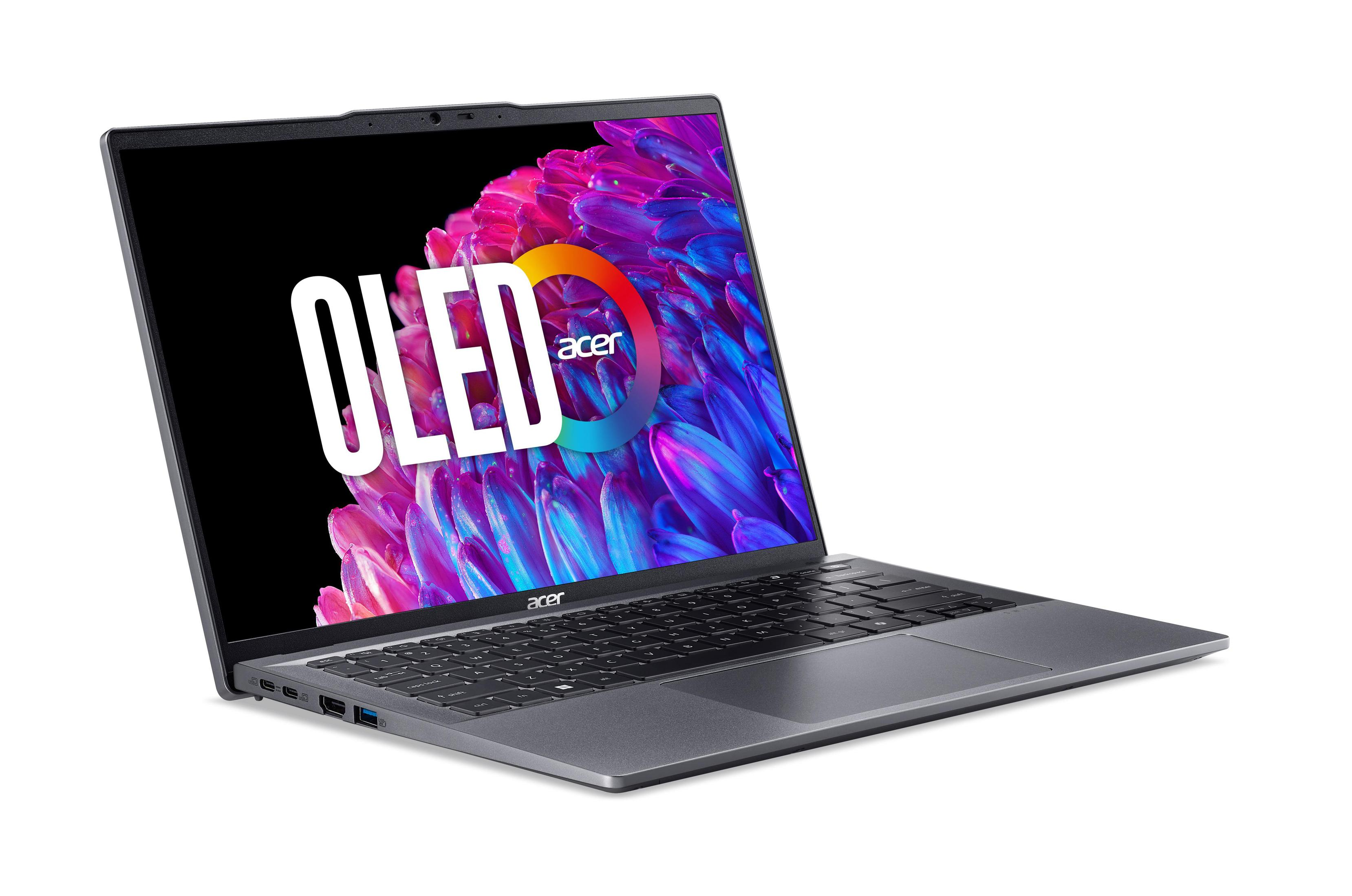 Laptop mit OLED-Bildschirm, der farbenfrohe Grafiken anzeigt, auf weißer Oberfläche.