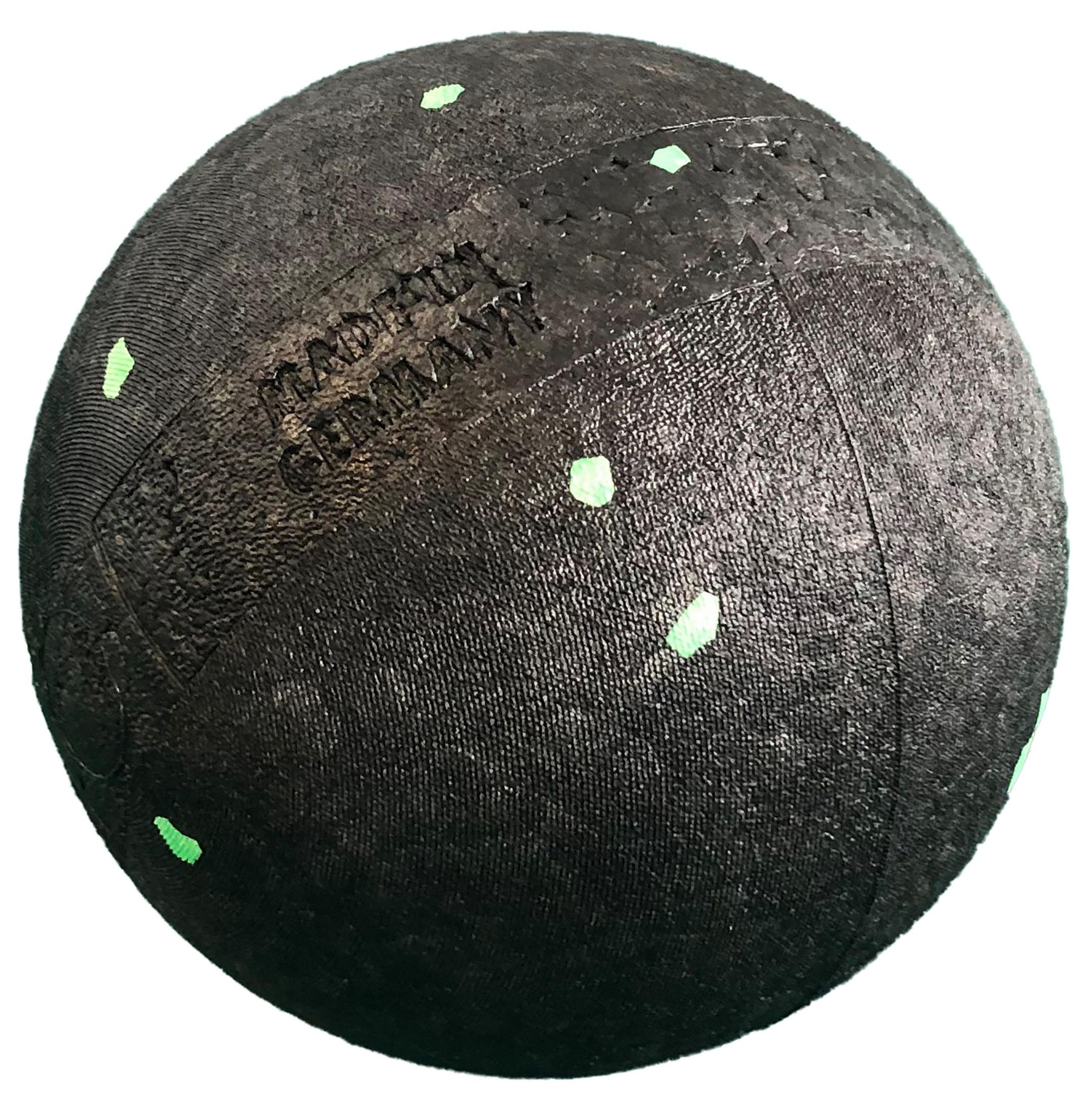 Schwarzer Massageball mit grünen Punkten. Der Ball hat eine strukturierte Oberfläche.