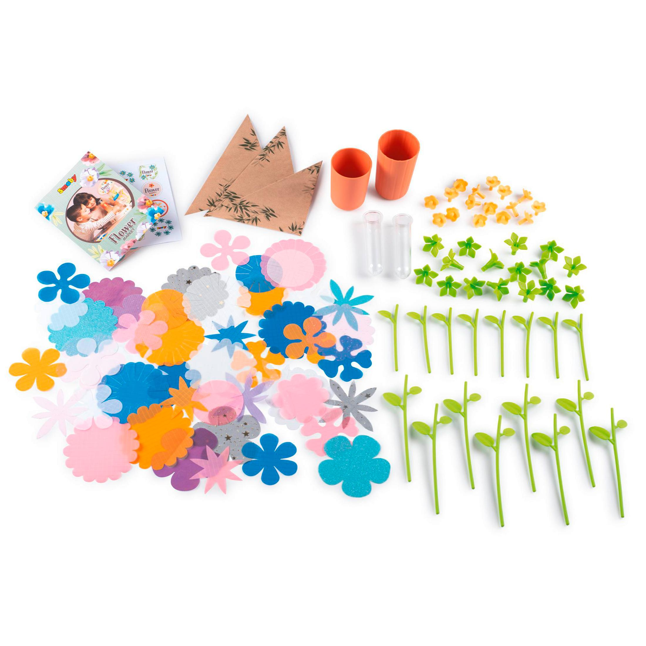 Ein Set Bastelmaterialien: Papierblumen, Blätter, Röhren und andere dekorative Artikel.
