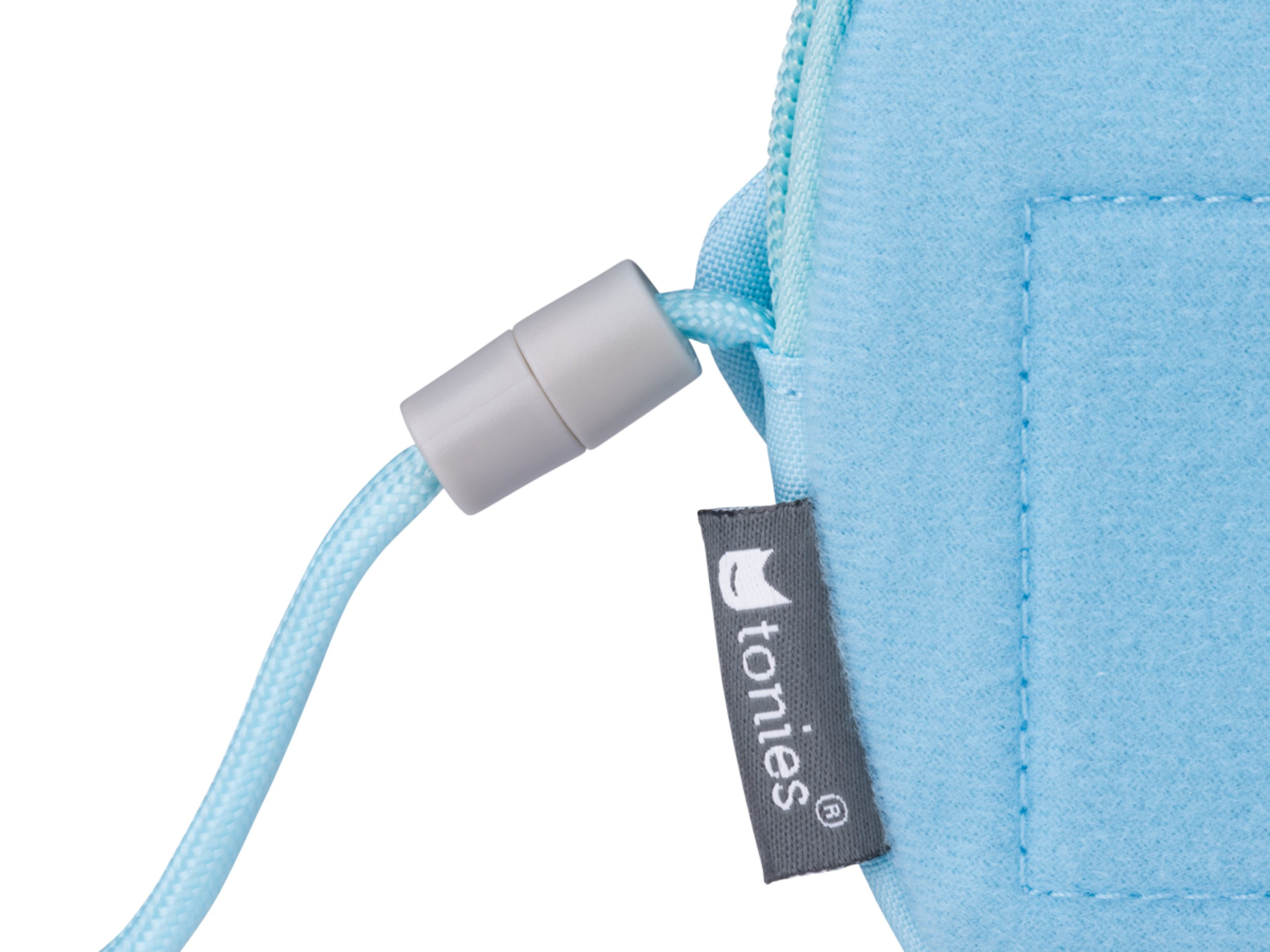 Hellblaue Tasche mit grauem Kordelzug und Etikett 'tonies'.