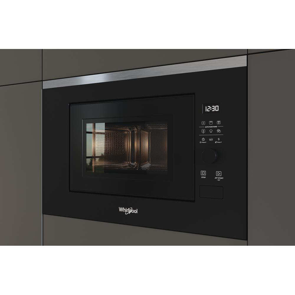 A built-in black Whirlpool microwave oven, with a digital display and buttons.