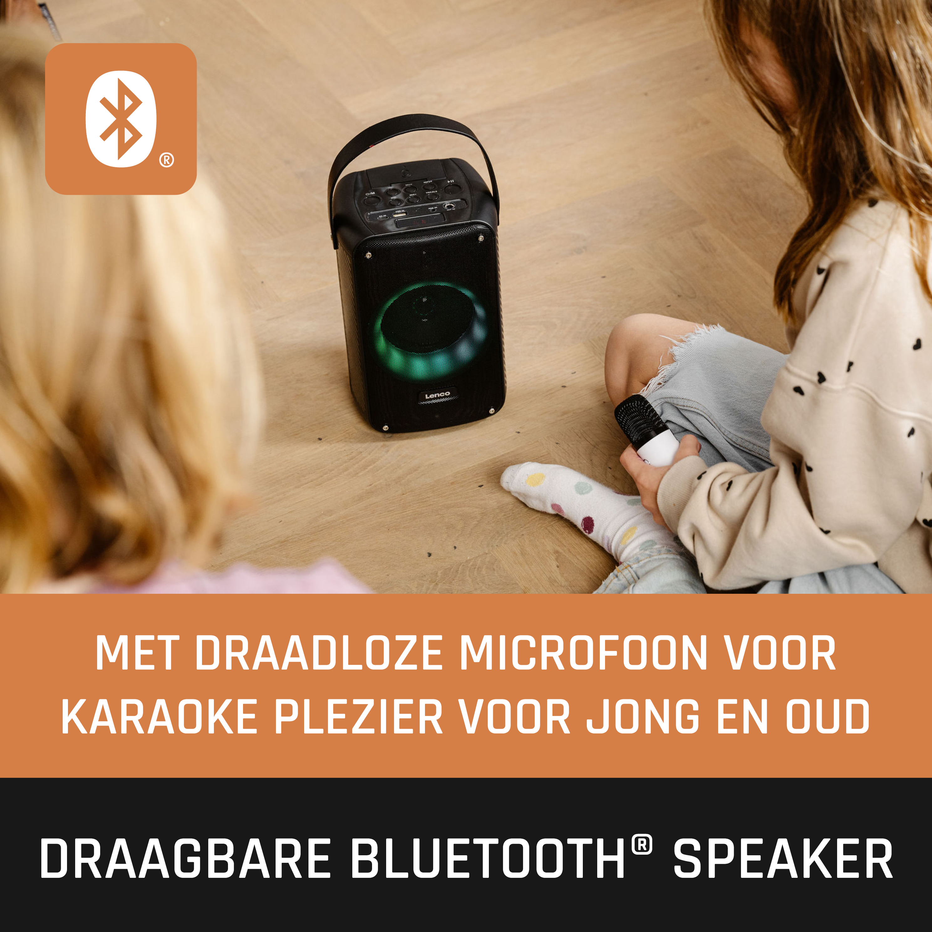 Draagbare bluetooth-luidspreker. Zwarte luidspreker met handvat en microfoon. Twee mensen op de achtergrond.