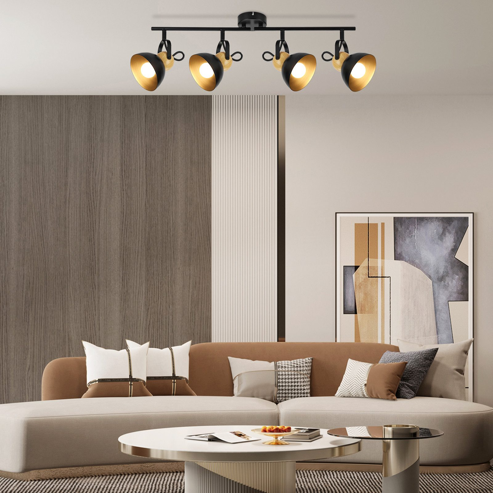 Czarne i złote reflektory sufitowe nad sofą i obrazem w nowoczesnym salonie.