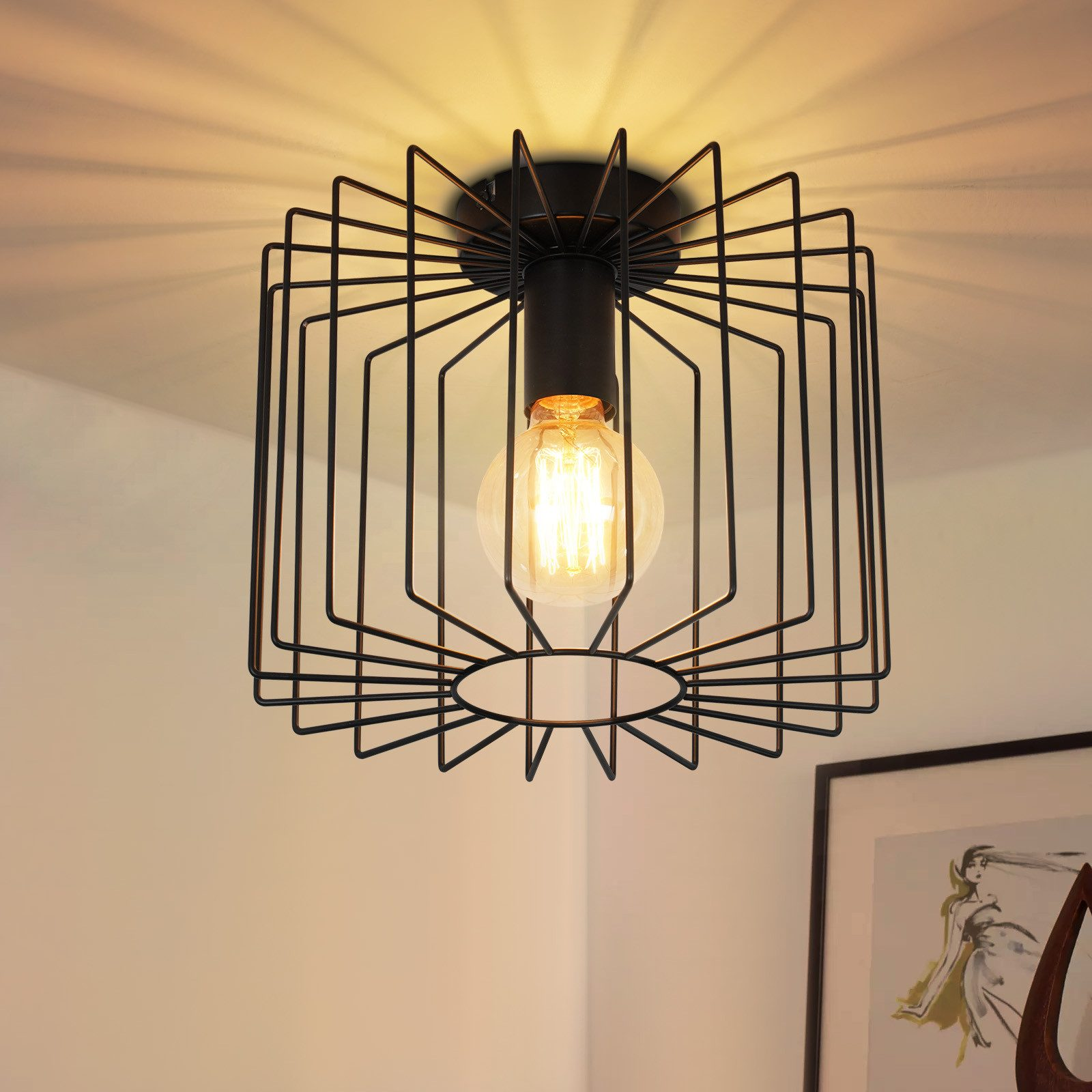 Lampada nera con design a gabbia. Una lampadina è al centro.