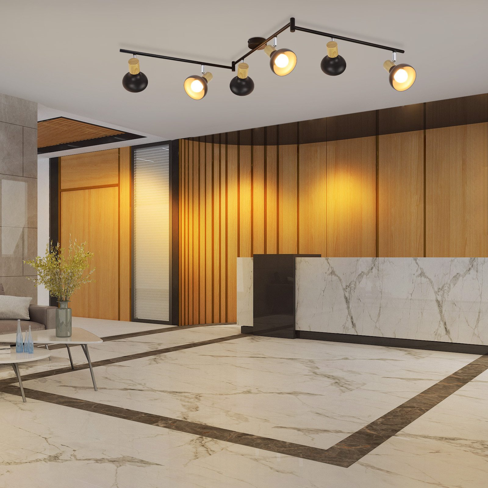 Hall con pavimento in marmo, pannelli in legno e faretti a soffitto. Sono visibili una reception e un vaso.