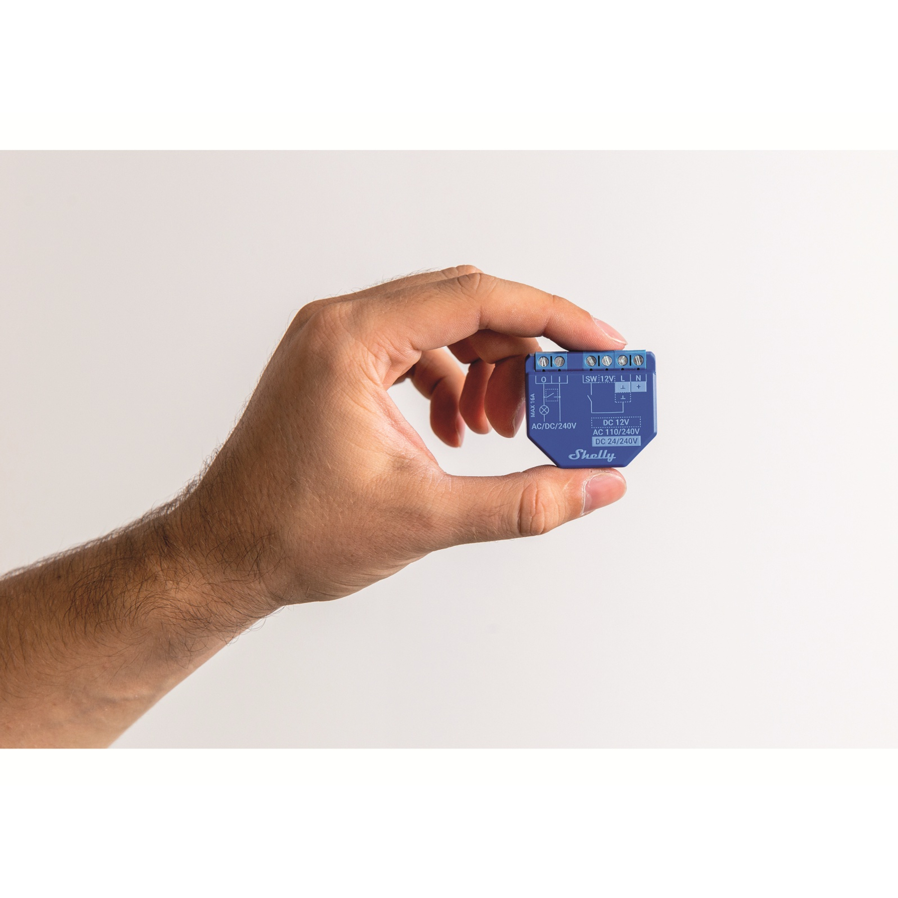 Hand hält ein blaues elektronisches Bauteil mit Etiketten. Weißer Hintergrund.