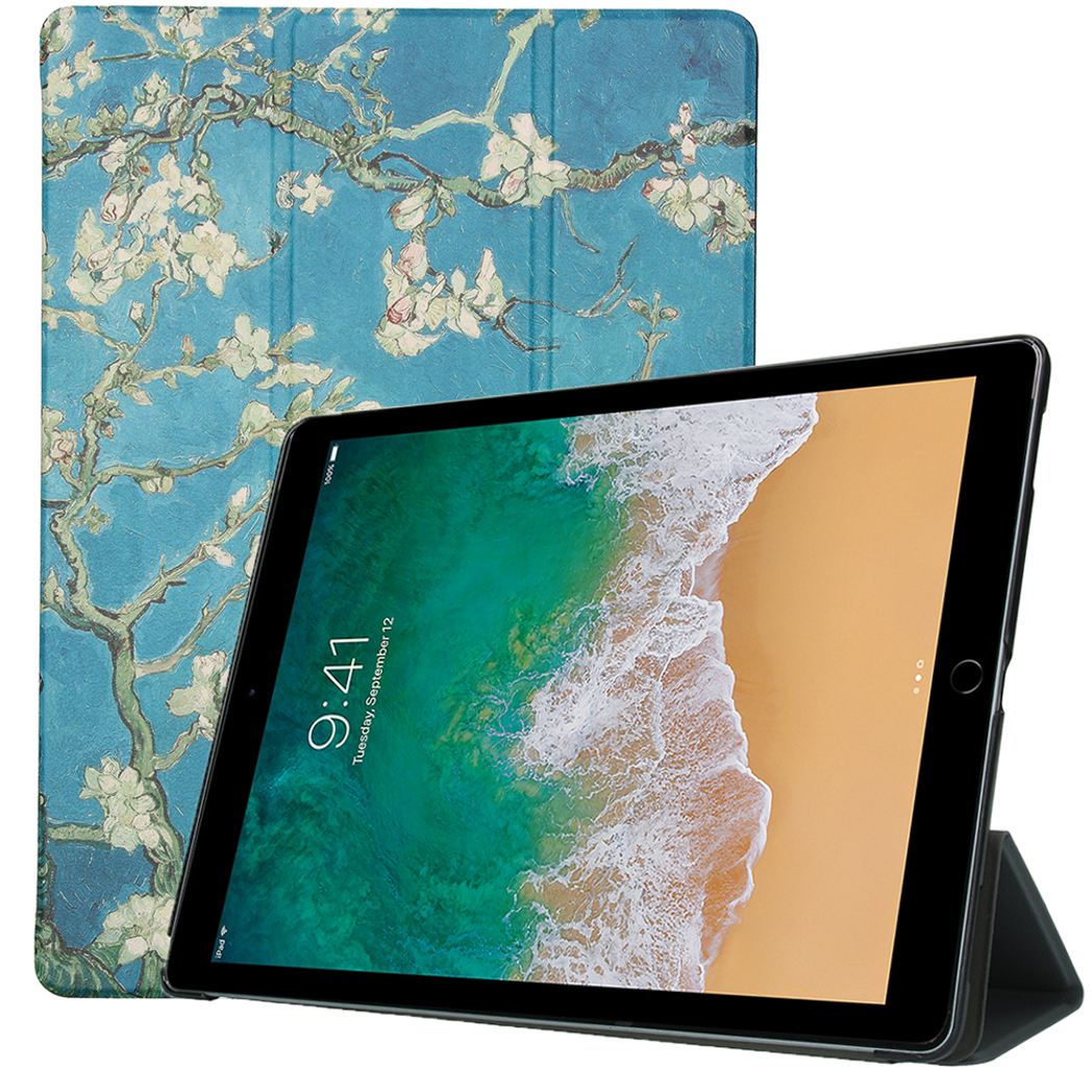 Tablet with a case. The case shows a painting with flowers and the tablet shows a beach.