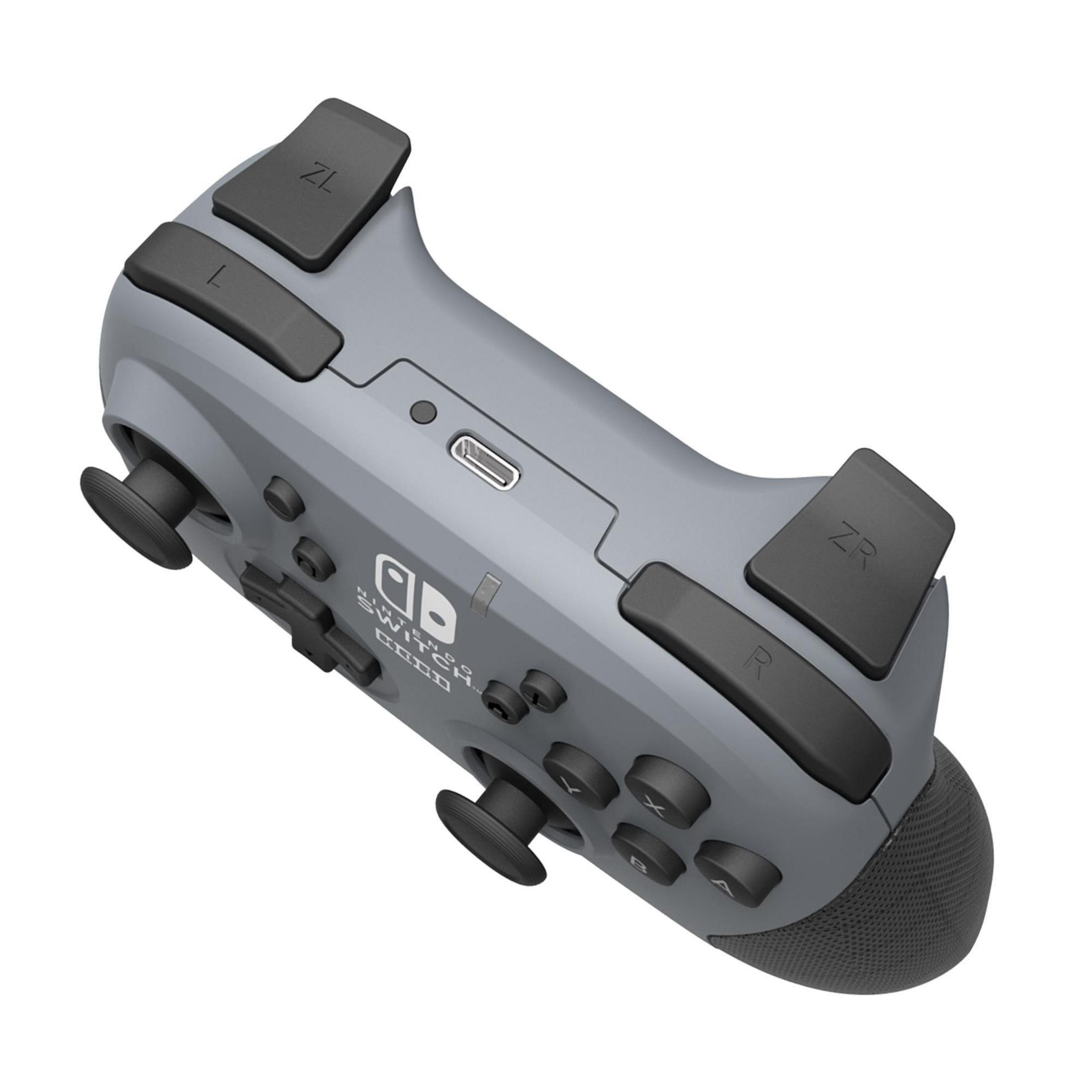 Szary gamepad z przyciskami i joystickami. Widoczne logo 'Switch' i 'Code'.