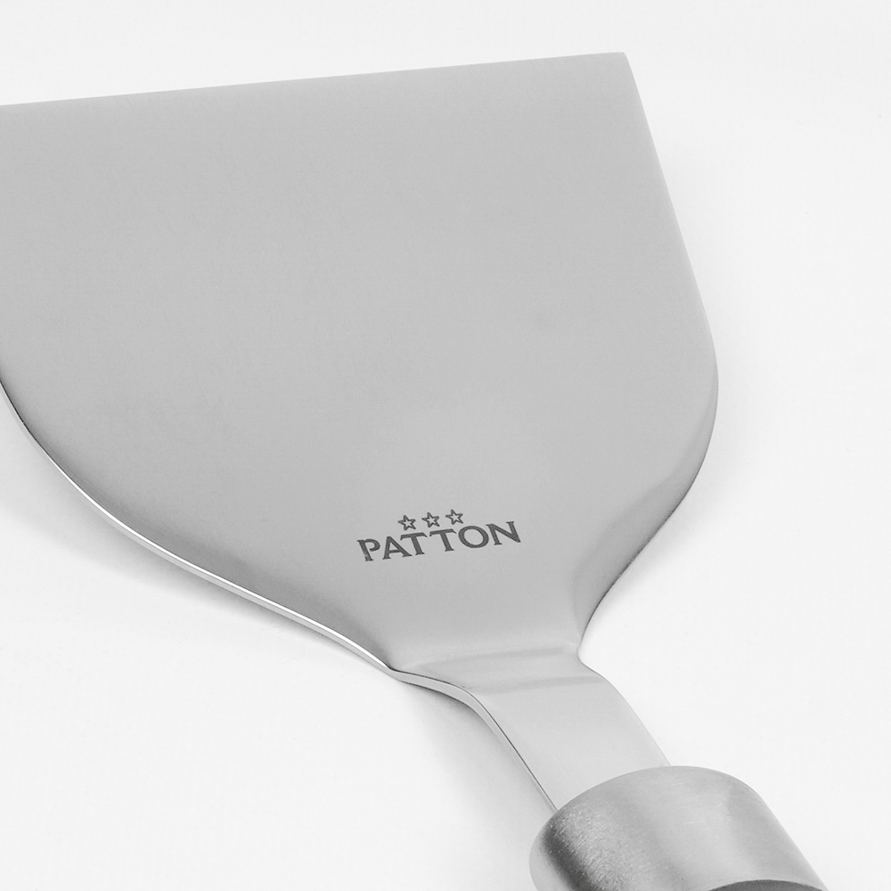 A stainless steel spatula with a wooden handle. The brand name, PATTON, is printed on the spatula.