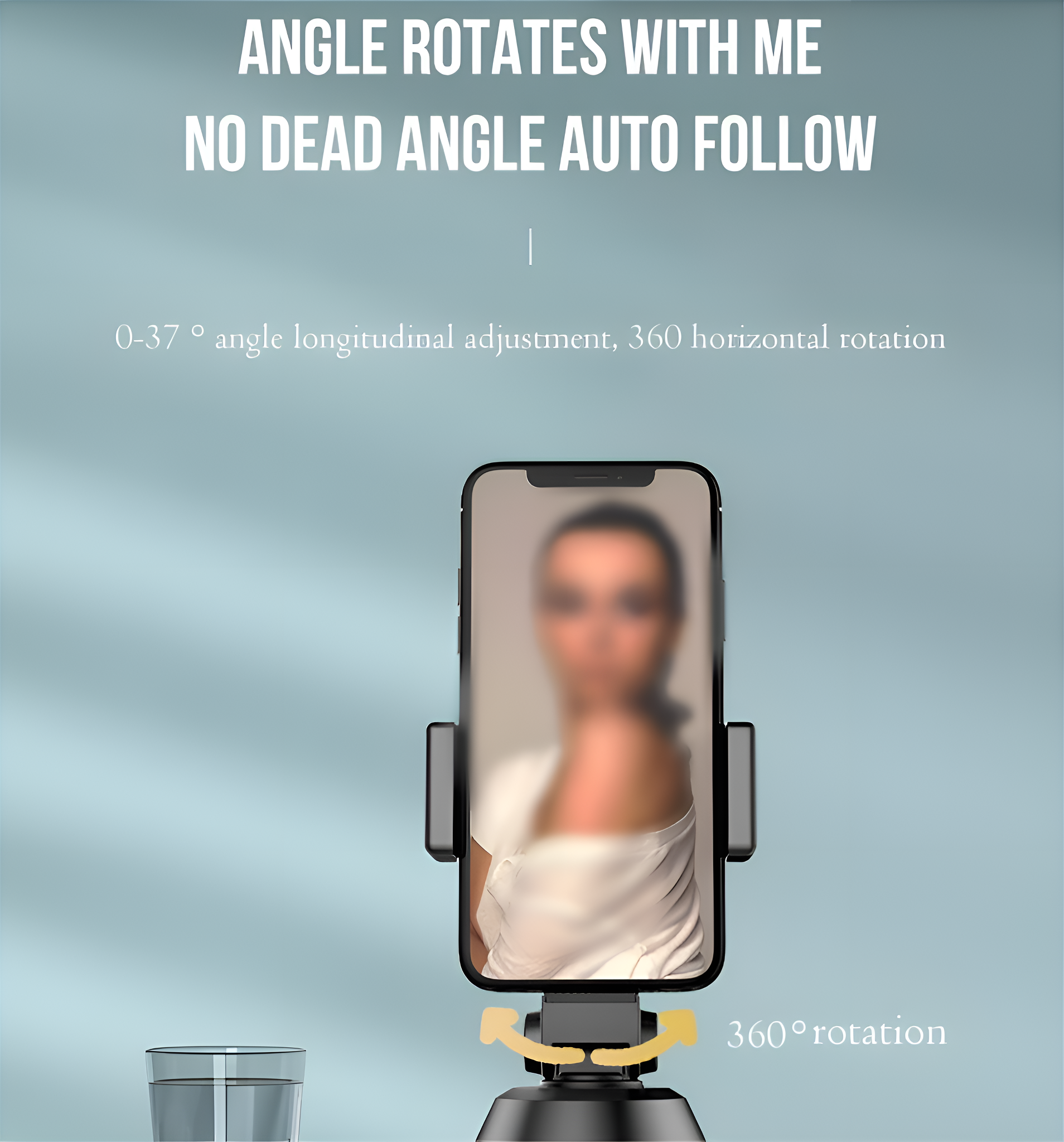 Ein Telefon steht in einem Ständer. Der Ständer kann sich drehen. Eine Frau ist unscharf auf dem Telefon.