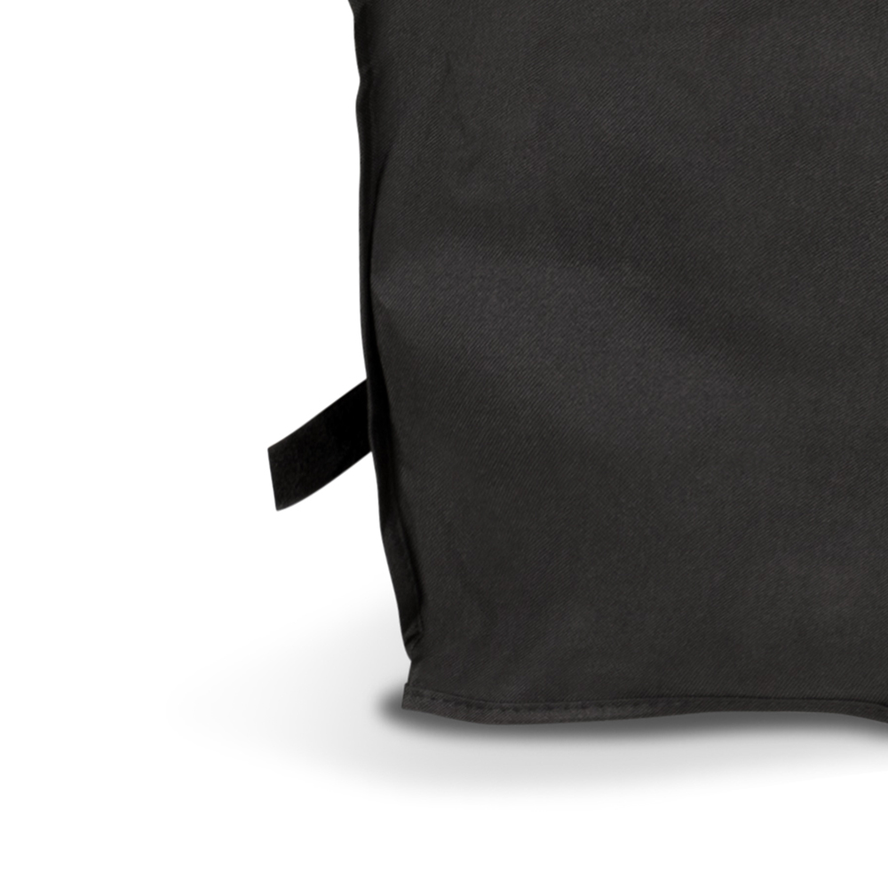 A corner of a black rectangular object with a velcro strap, against a white background.