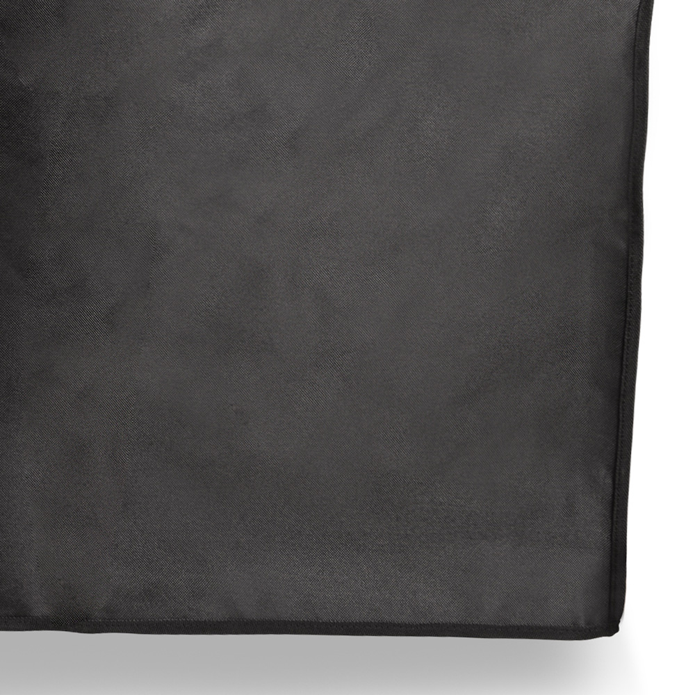 Close up of a black, textured cloth with a sewn border, against a white background.