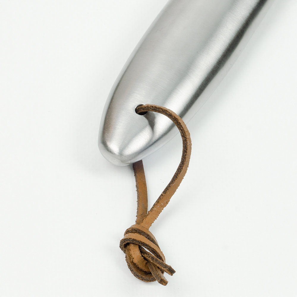 Metal utensil with a leather loop. Shiny, silver metal and brown leather.