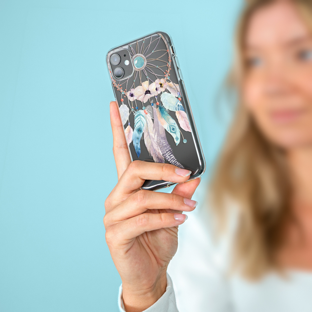 Een persoon die een telefoon vasthoudt met een hoesje met dromenvanger design.