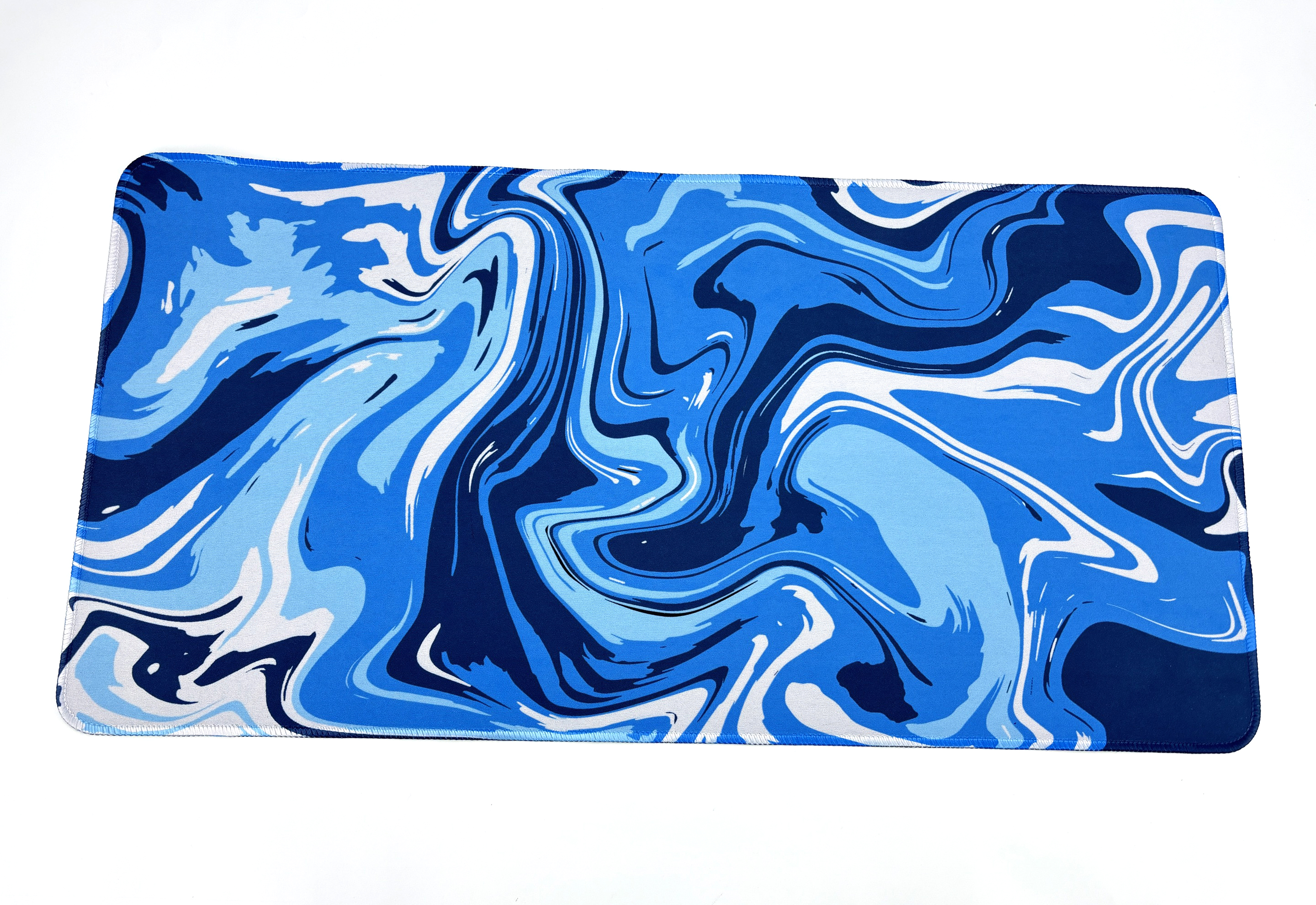 A blue and white marbled design mouse pad, with a black border, on a white surface.