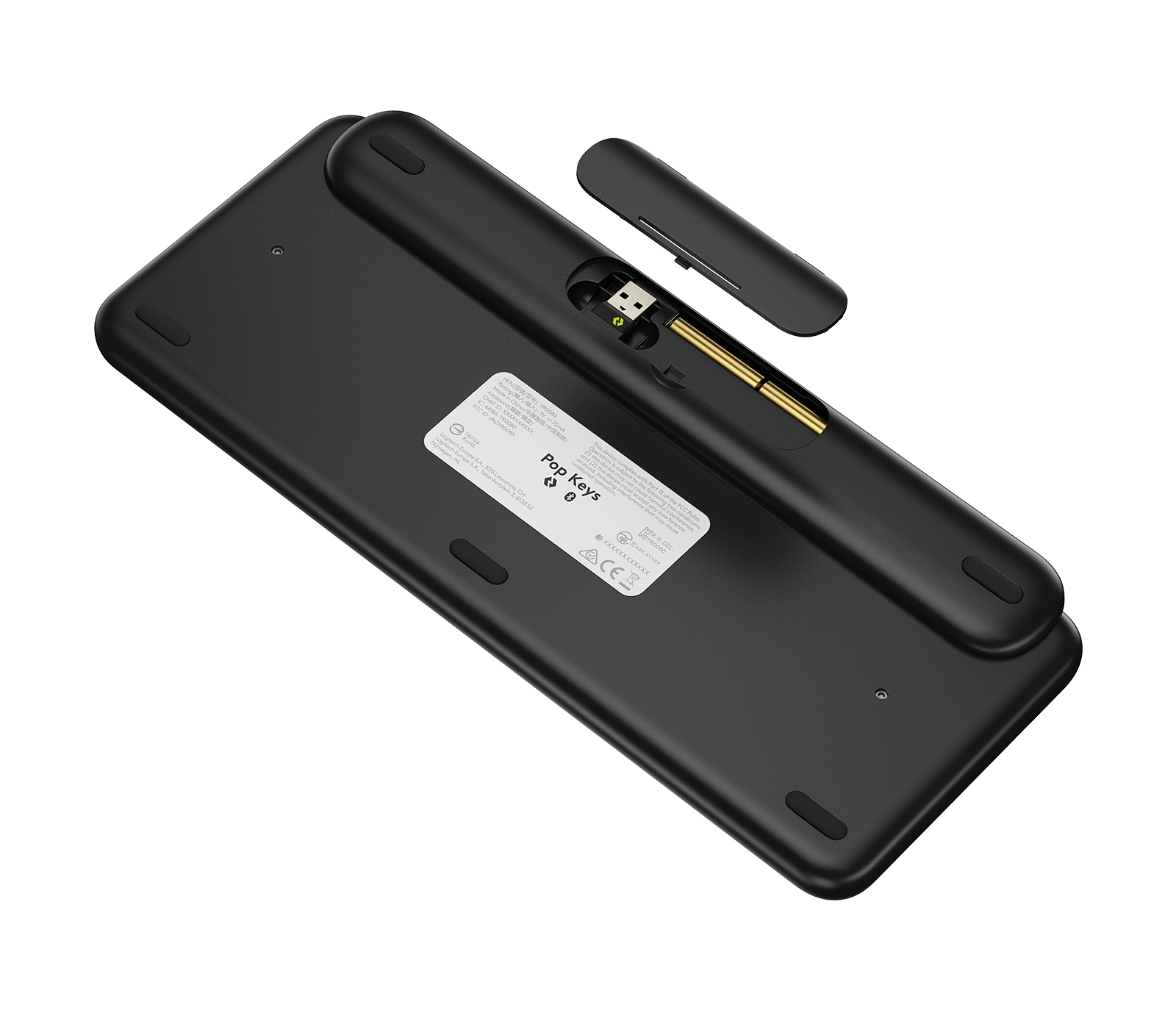 Unterseite der schwarzen Tastatur. Ein Fach für den USB-Empfänger ist geöffnet, mit USB.