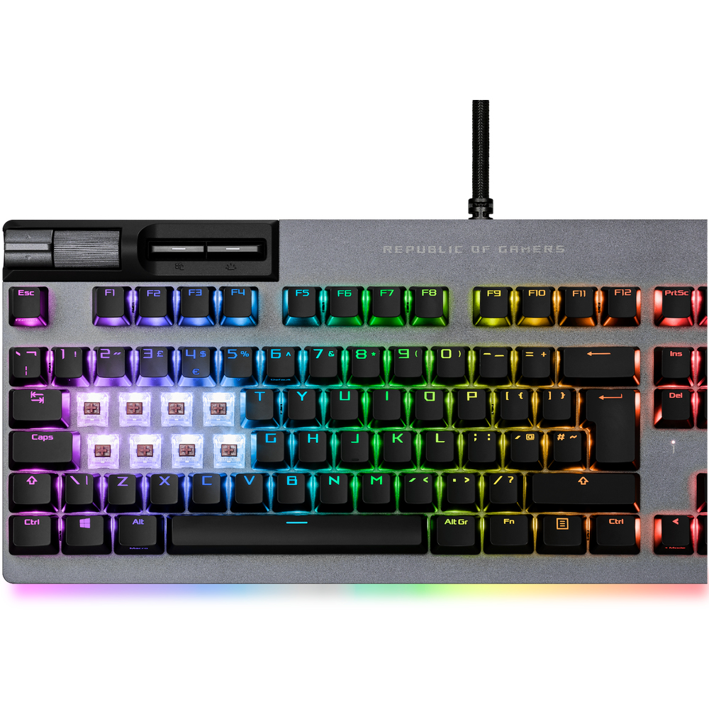Teclado iluminado RGB con base gris y teclas coloridas. Teclas grises y blancas.