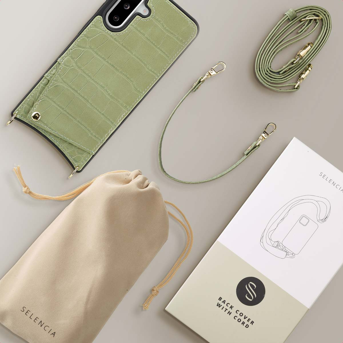 Coque de téléphone à imprimé crocodile vert avec sangle, pochette beige et une coque arrière avec boîte de cordon.