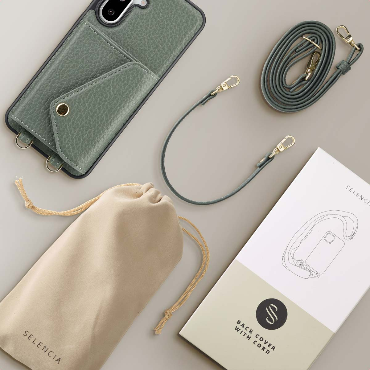 Telefoon, koord en etui op een grijze ondergrond. Verpakking toont een telefoonhoes-illustratie.