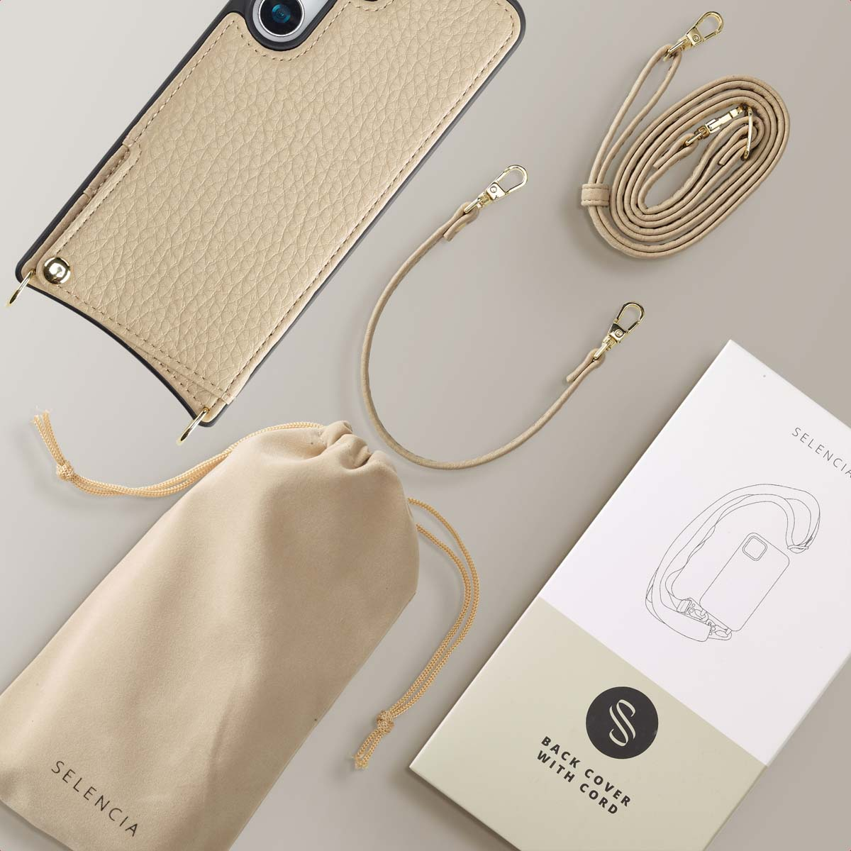 Custodia per telefono con cinturino, borsa e scatola. Custodia, cinturino e borsa beige. La scatola mostra l'immagine.