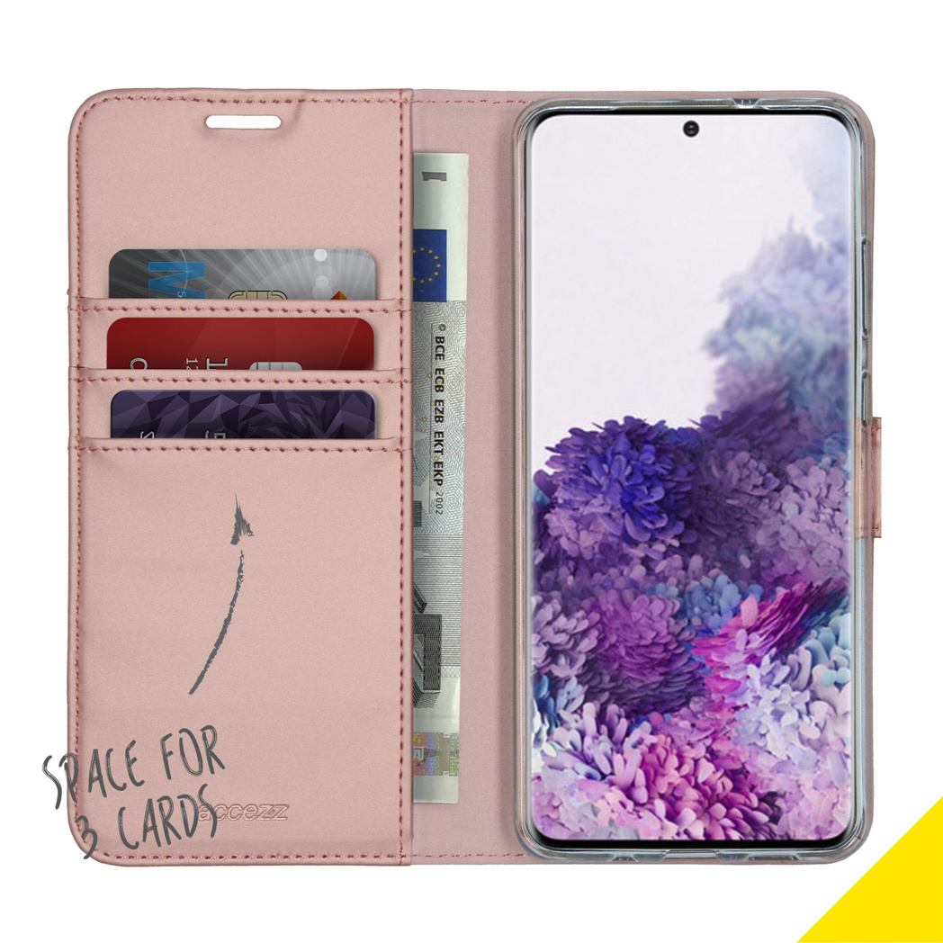 Étui de téléphone rose, ouvert, montrant cartes, argent et écran de téléphone.