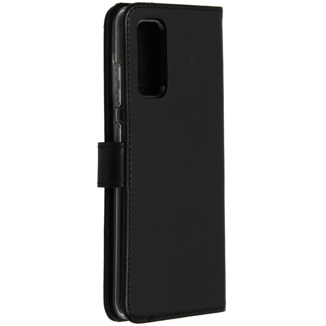 Étui de téléphone noir ouvert, montrant le téléphone et l'intérieur, avec fermoir magnétique.