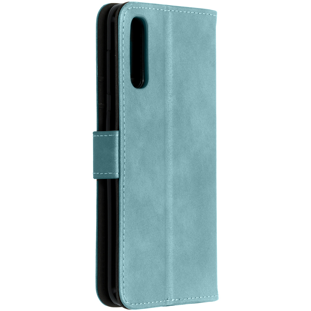 Un étui de téléphone turquoise avec un téléphone noir à l'intérieur. L'étui est fermé.