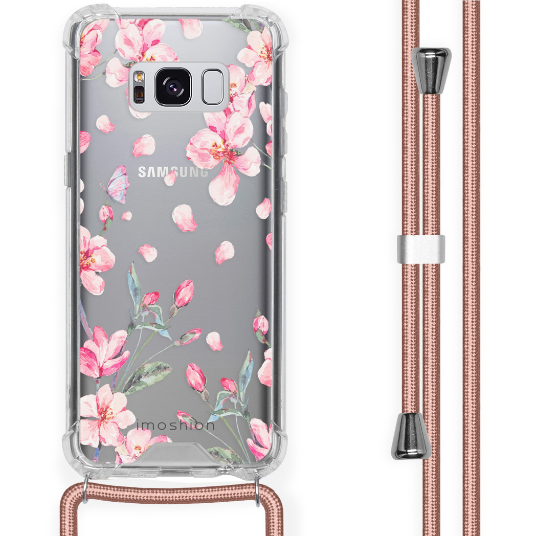 Coque transparente avec fleurs roses et cordon rose. Le téléphone est visible.