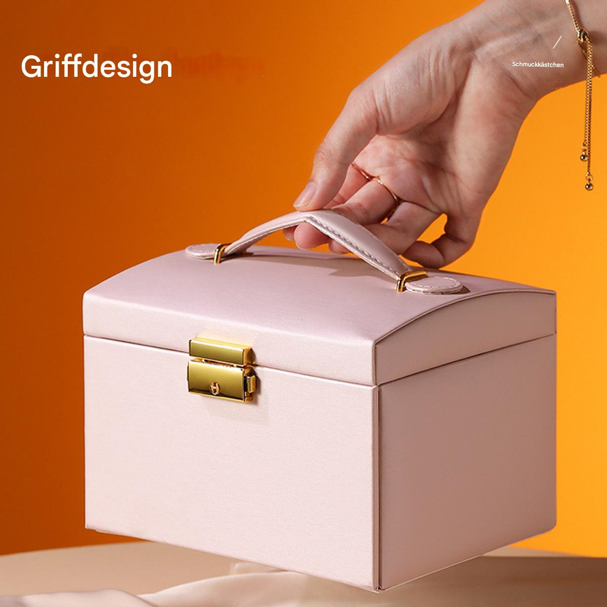 Rosa Schmuckkasten mit Griff. Hand hält die Box.