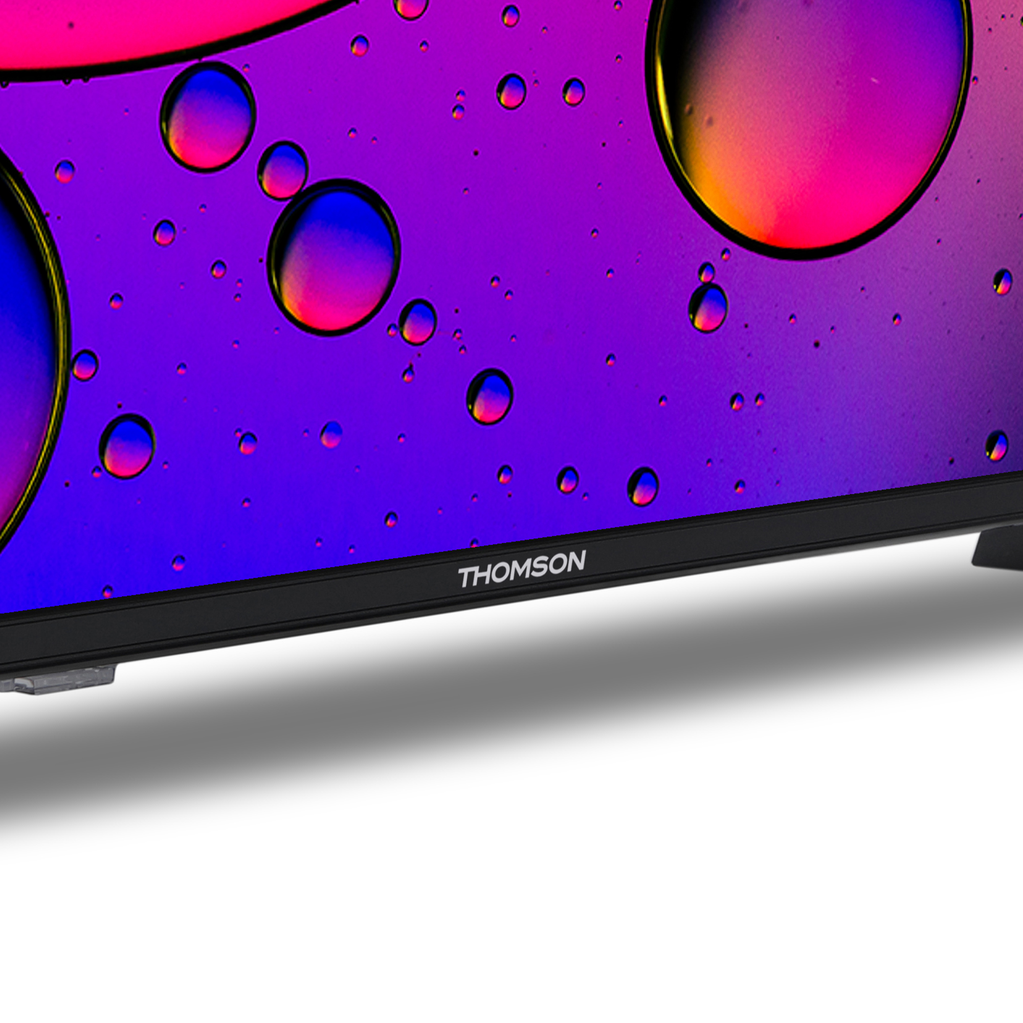 Primo piano di uno schermo TV. Lo schermo mostra cerchi colorati su sfondo nero.