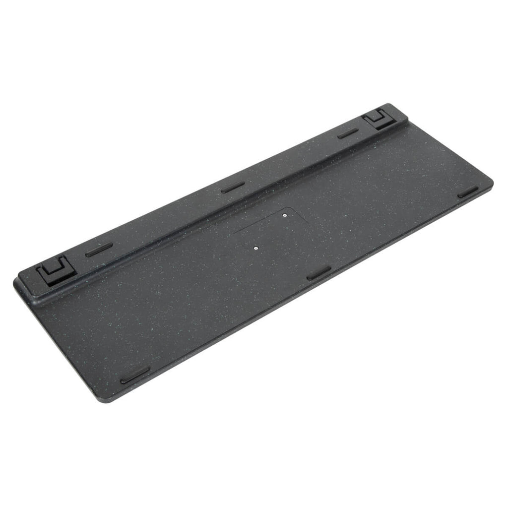 The underside of a black, textured keyboard. It has rectangular feet and recessed areas.