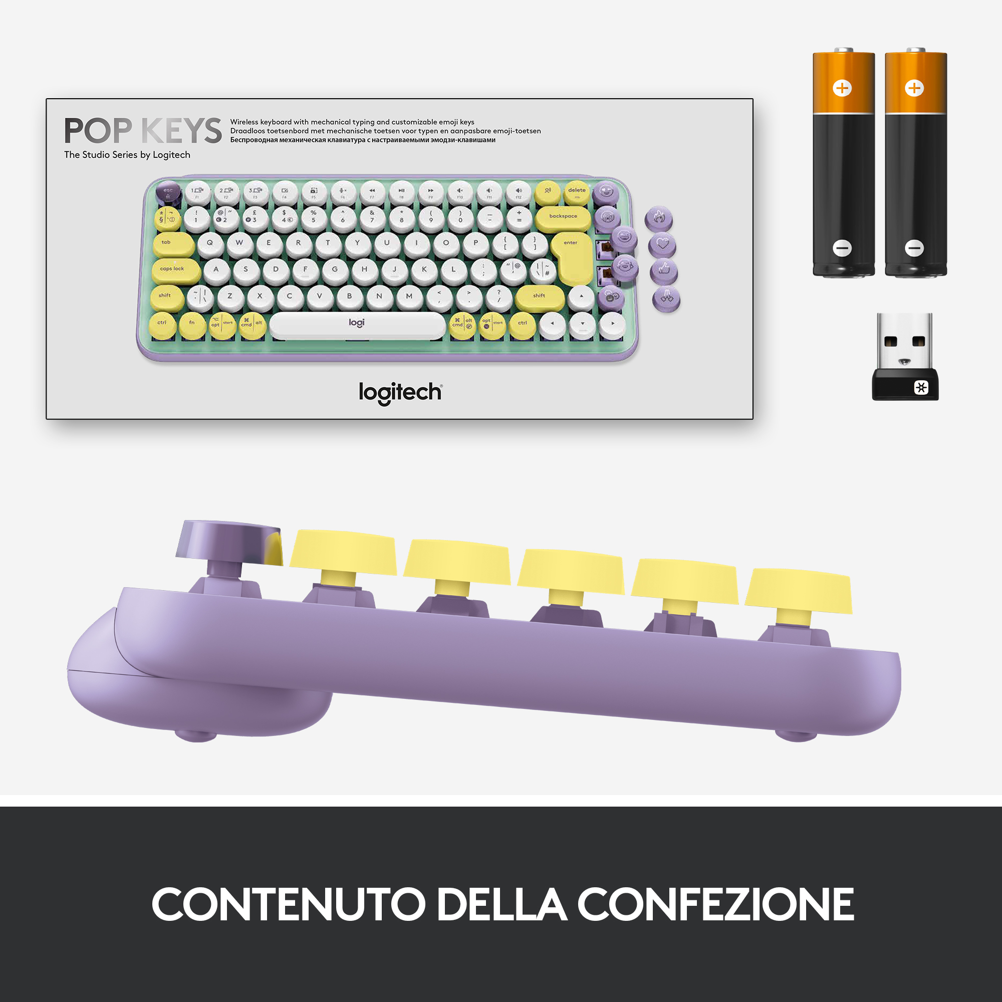 Una tastiera e accessori in una scatola. La tastiera è viola e gialla.