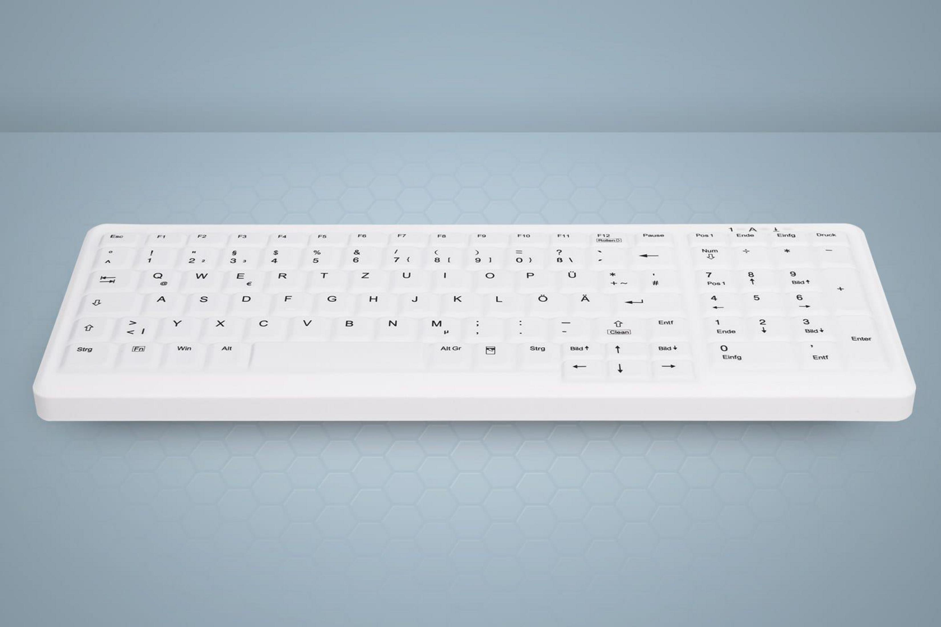 Weiße Tastatur, auf blau-grauem Farbverlauf-Hintergrund.