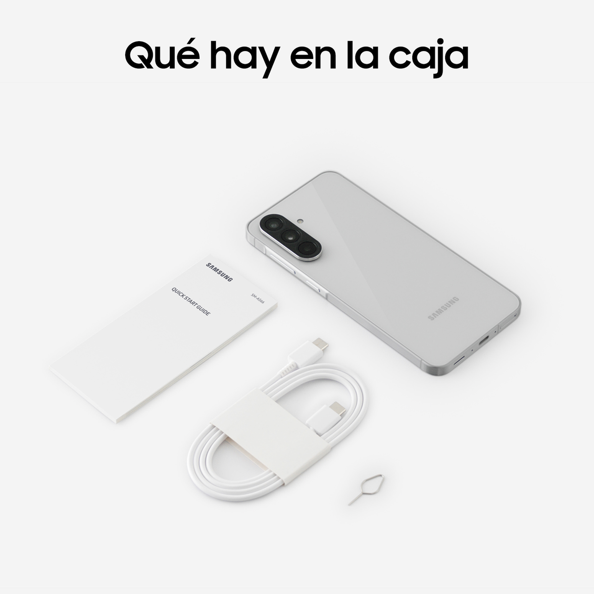 Zawartość pudełka telefonu: telefon, ładowarka, kabel i narzędzie SIM na białej powierzchni.