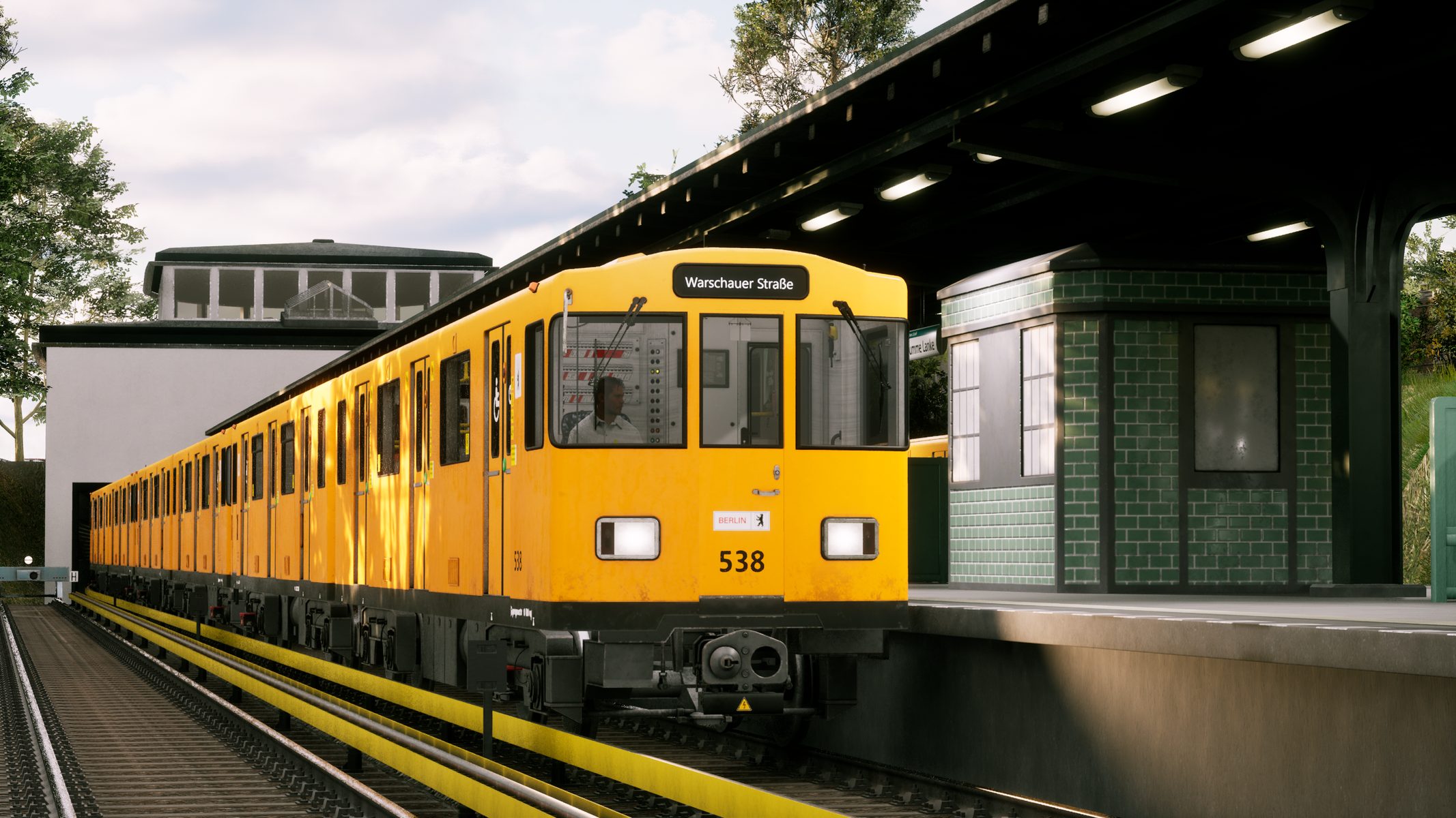 Żółty pociąg U-Bahn w Berlinie na stacji, ze znakiem „Warschauer Straße”.