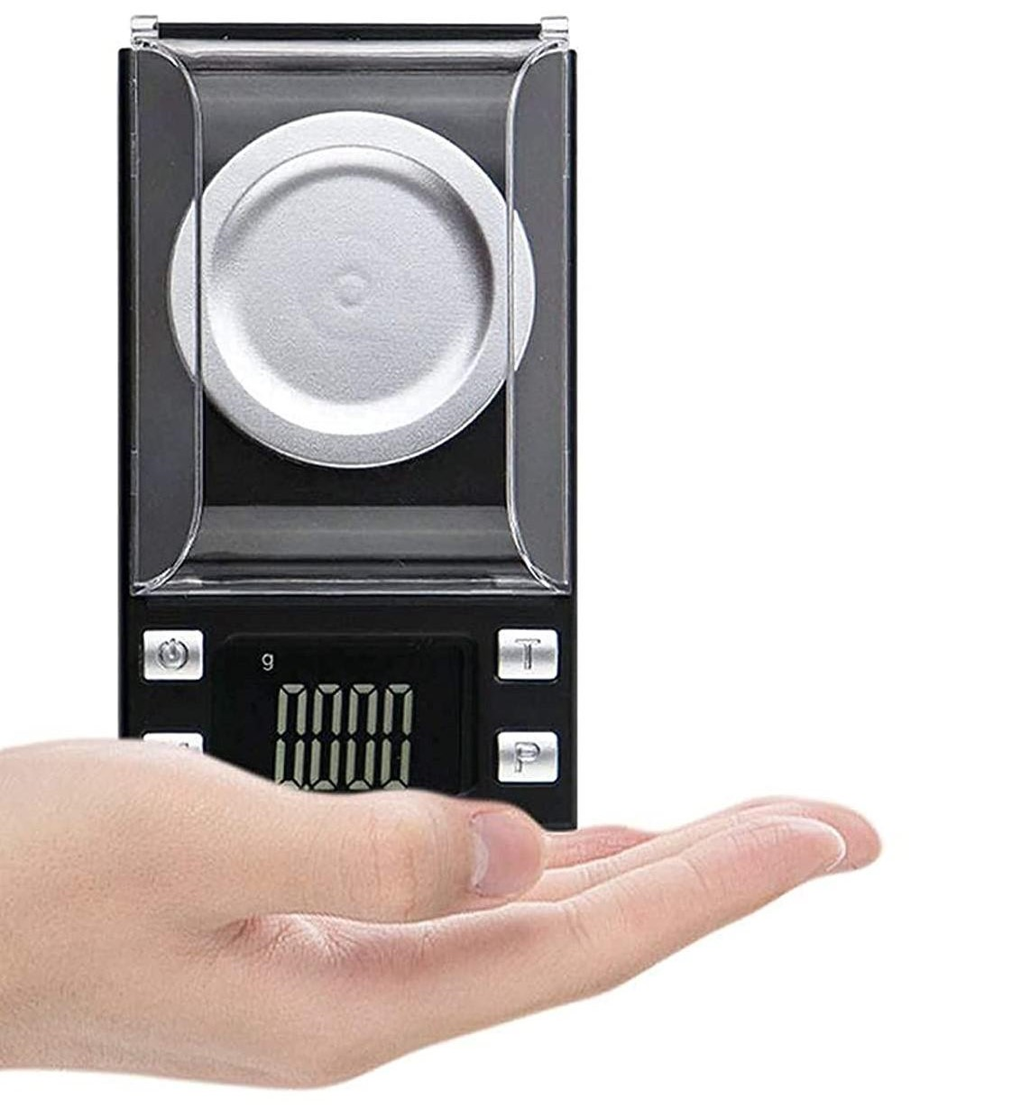 Waga cyfrowa trzymana w dłoni. Ma ekran i przyciski. Odczyt wynosi 0,0000.