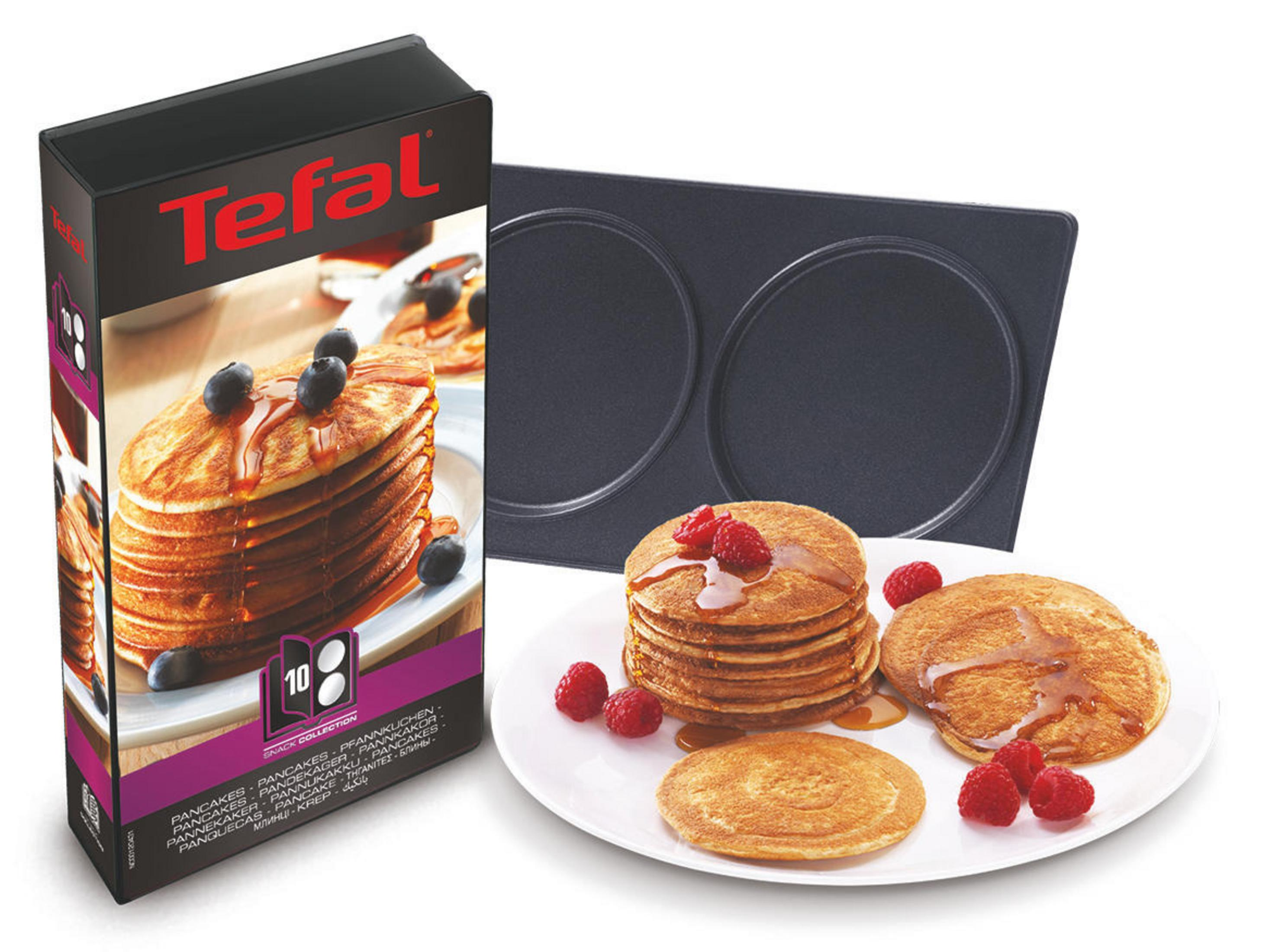 Pancake maker box and pancakes with syrup and berries.