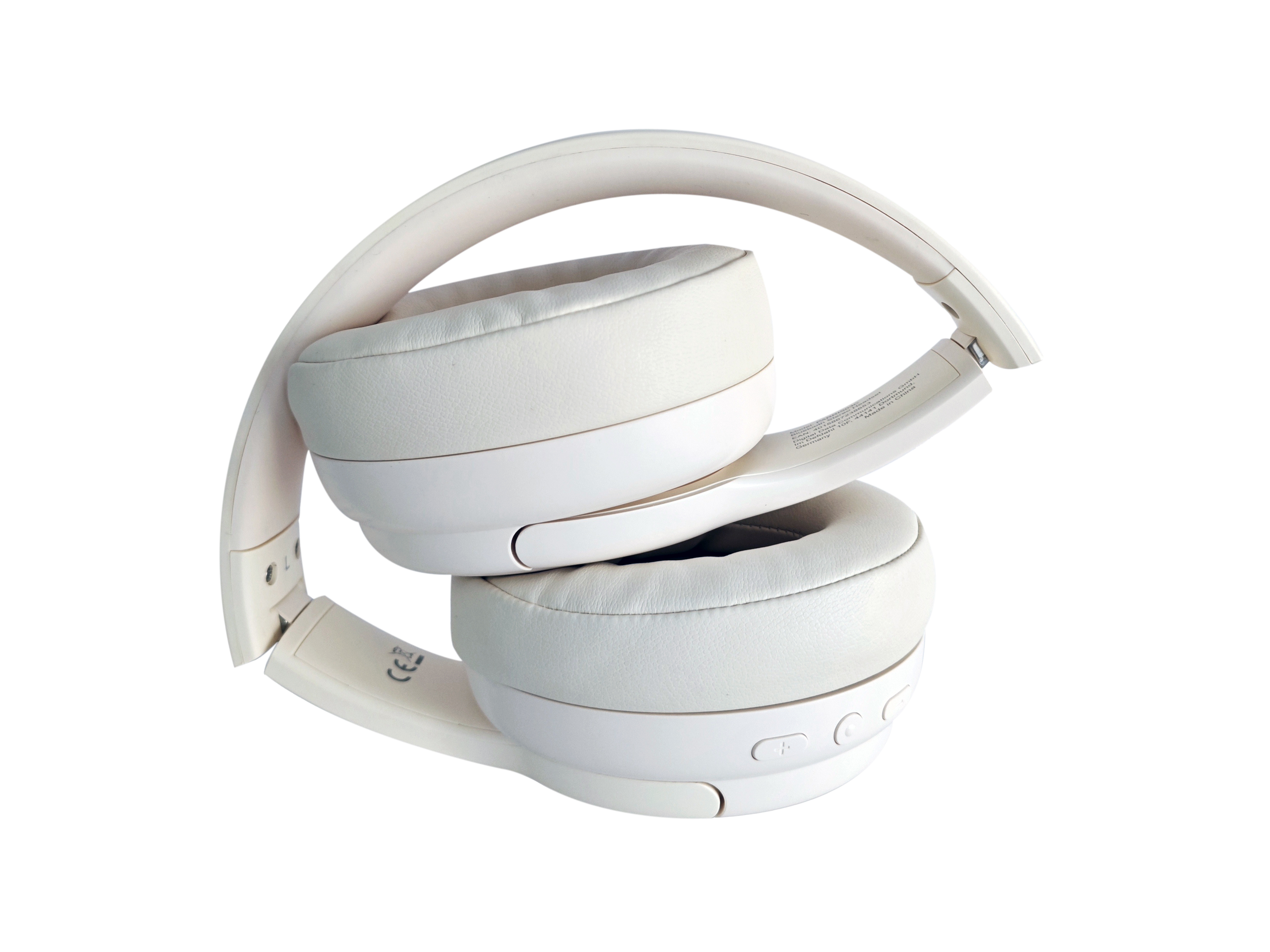 Cuffie bianche piegate su sfondo bianco. Padiglioni auricolari e archetto visibili.