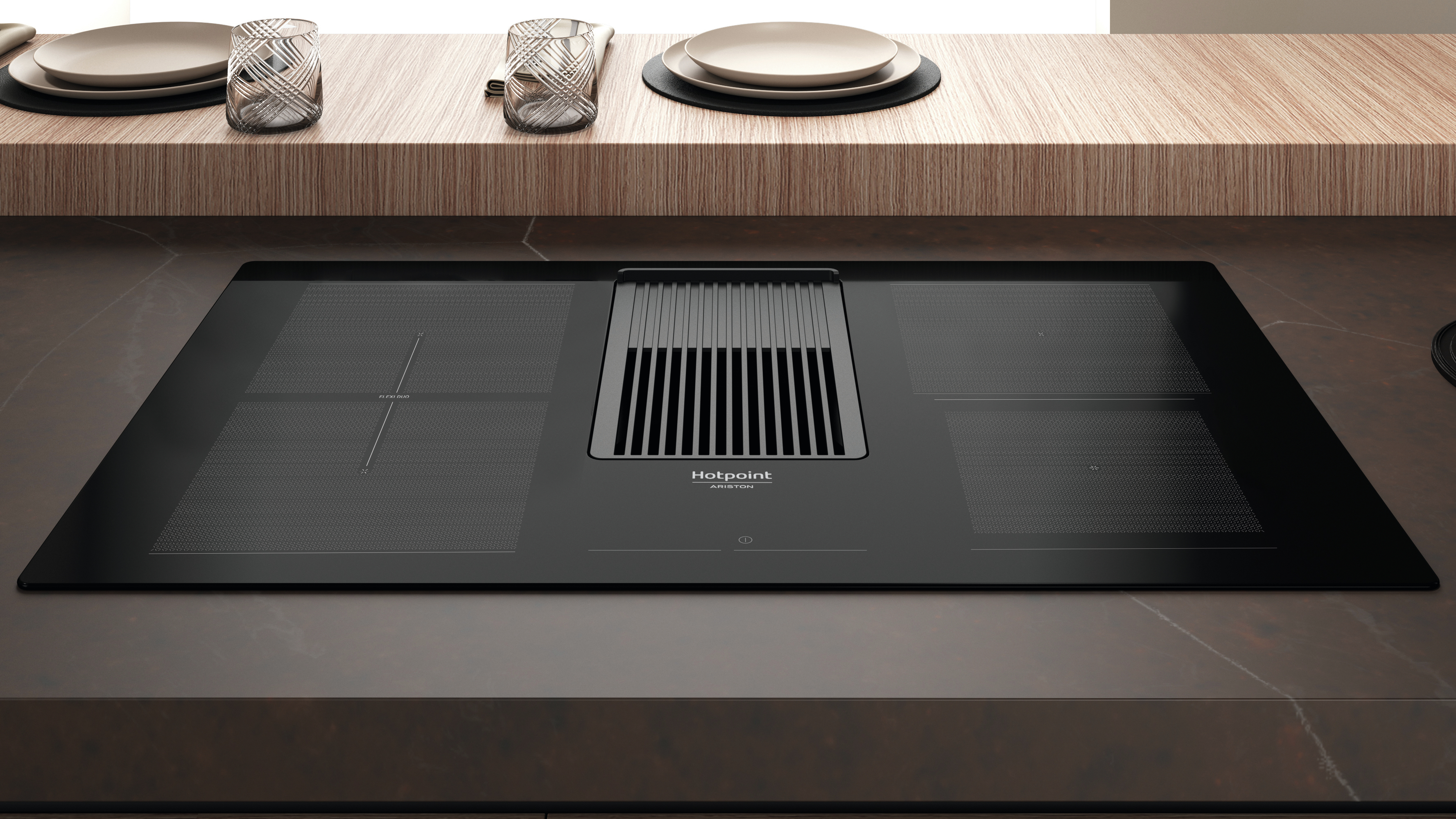 Piano cottura nero con ventilazione integrata. È su un piano di lavoro marrone.
