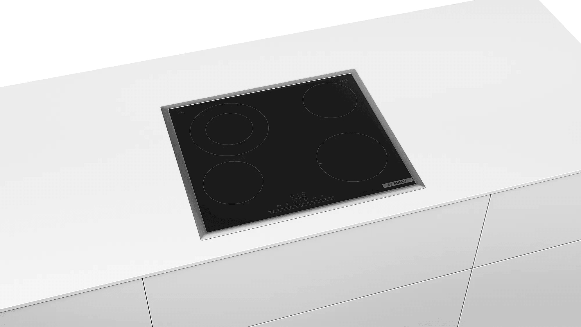 Plaque de cuisson noire avec quatre brûleurs encastrée dans un plan de travail blanc. Logo Bosch.
